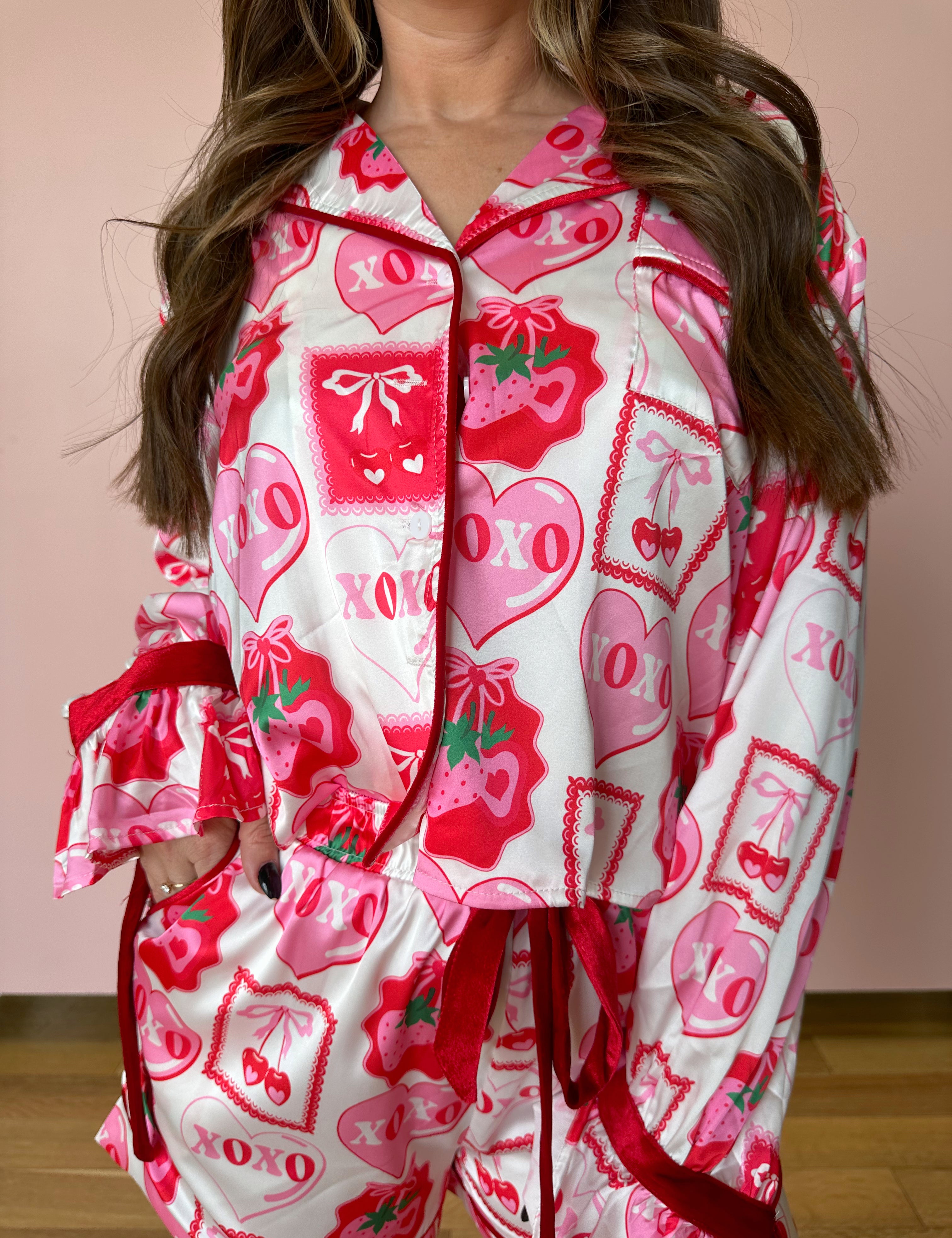 Pink stain pajama set with heart and cherry detailing. 