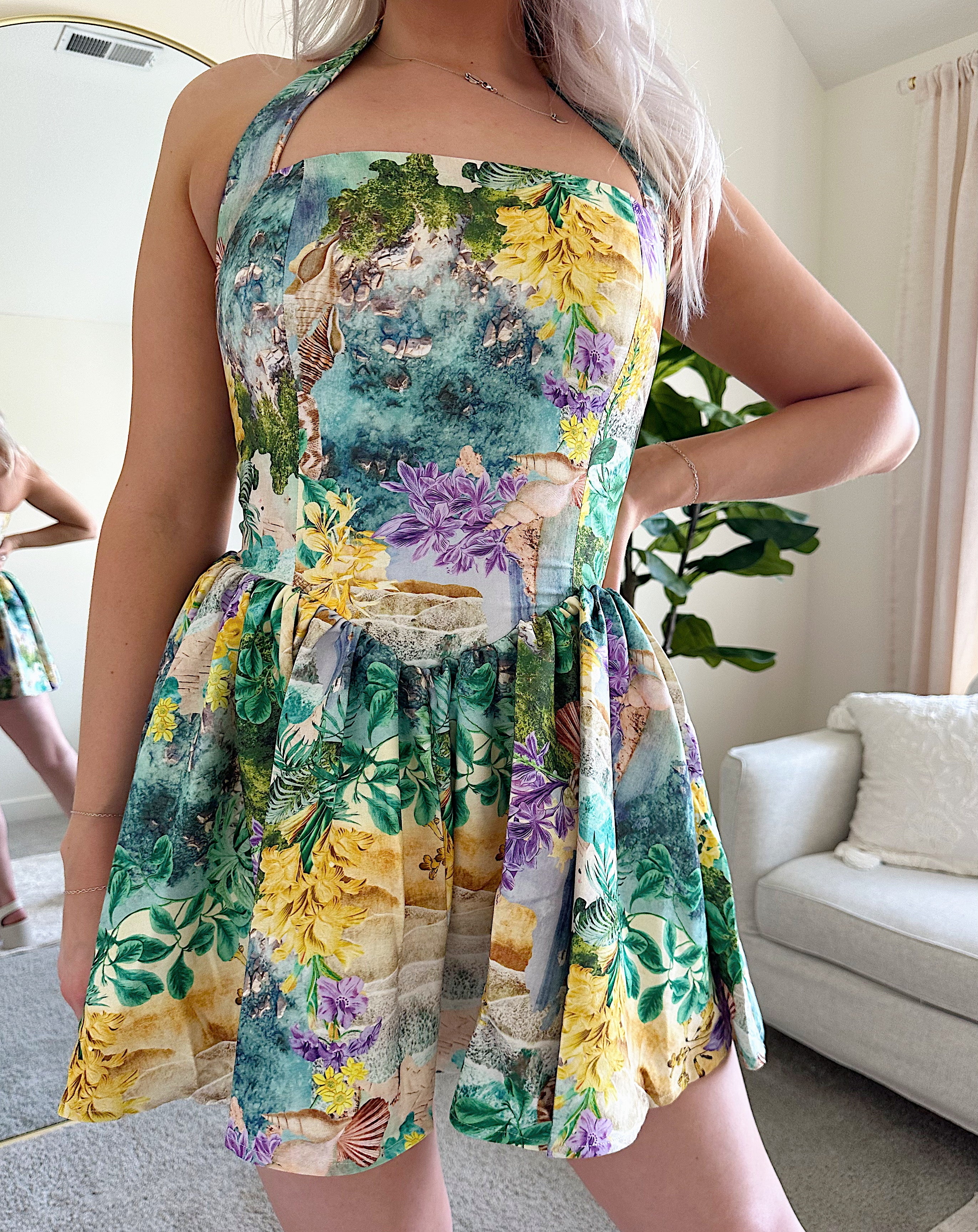 Green and purple tropical print mini dress with halter neckline.