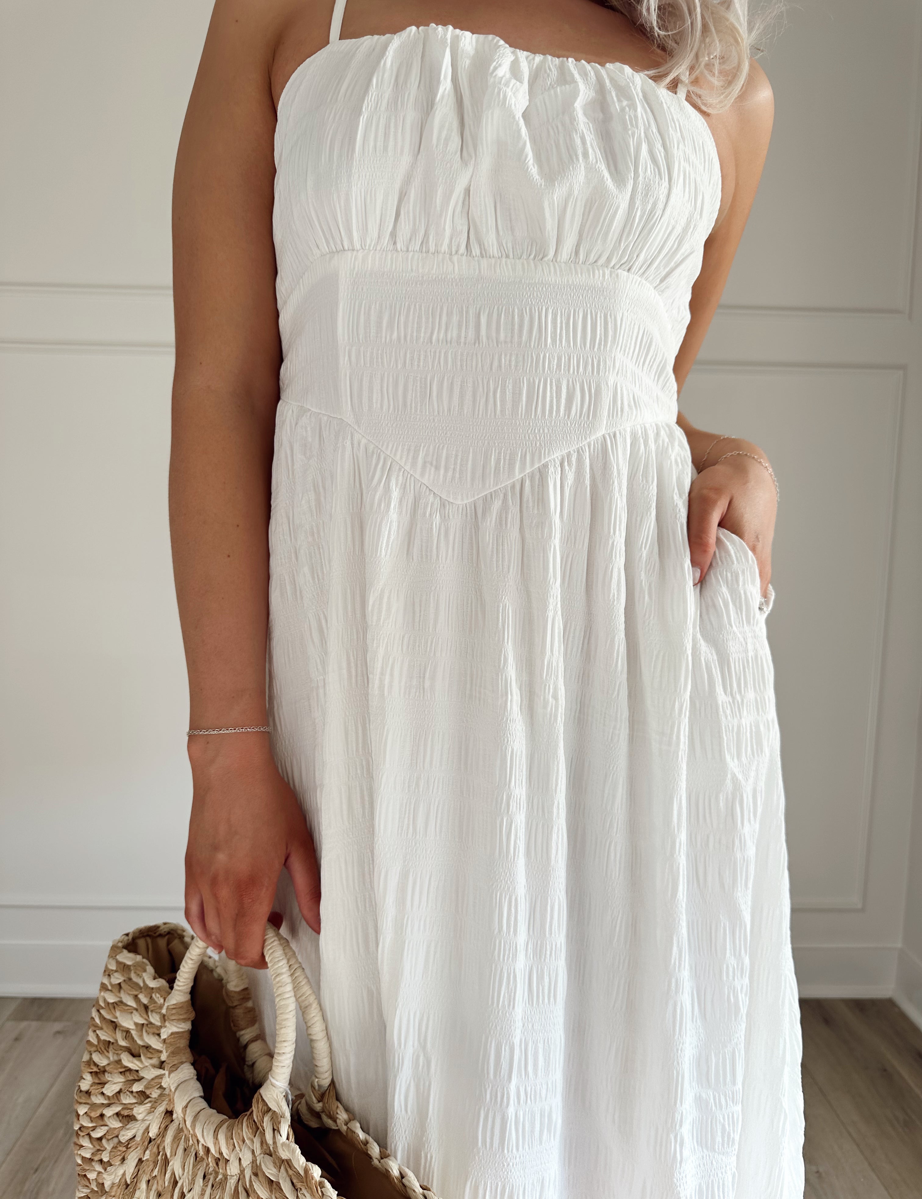 White textured midi dress with corset lining midsection and functional pockets.