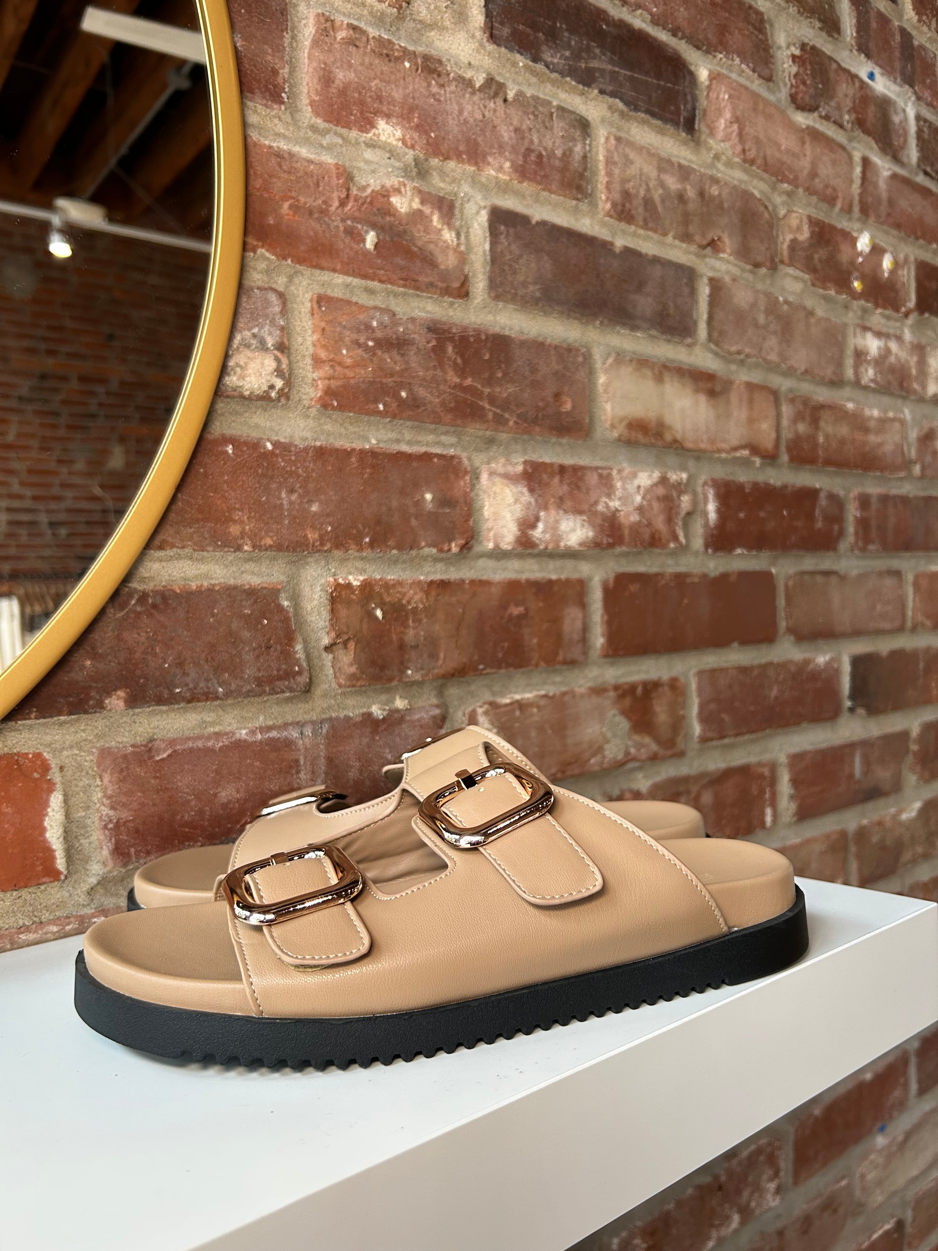Brown flat sandal with good hardware buckle. Perfect for everyday wear.