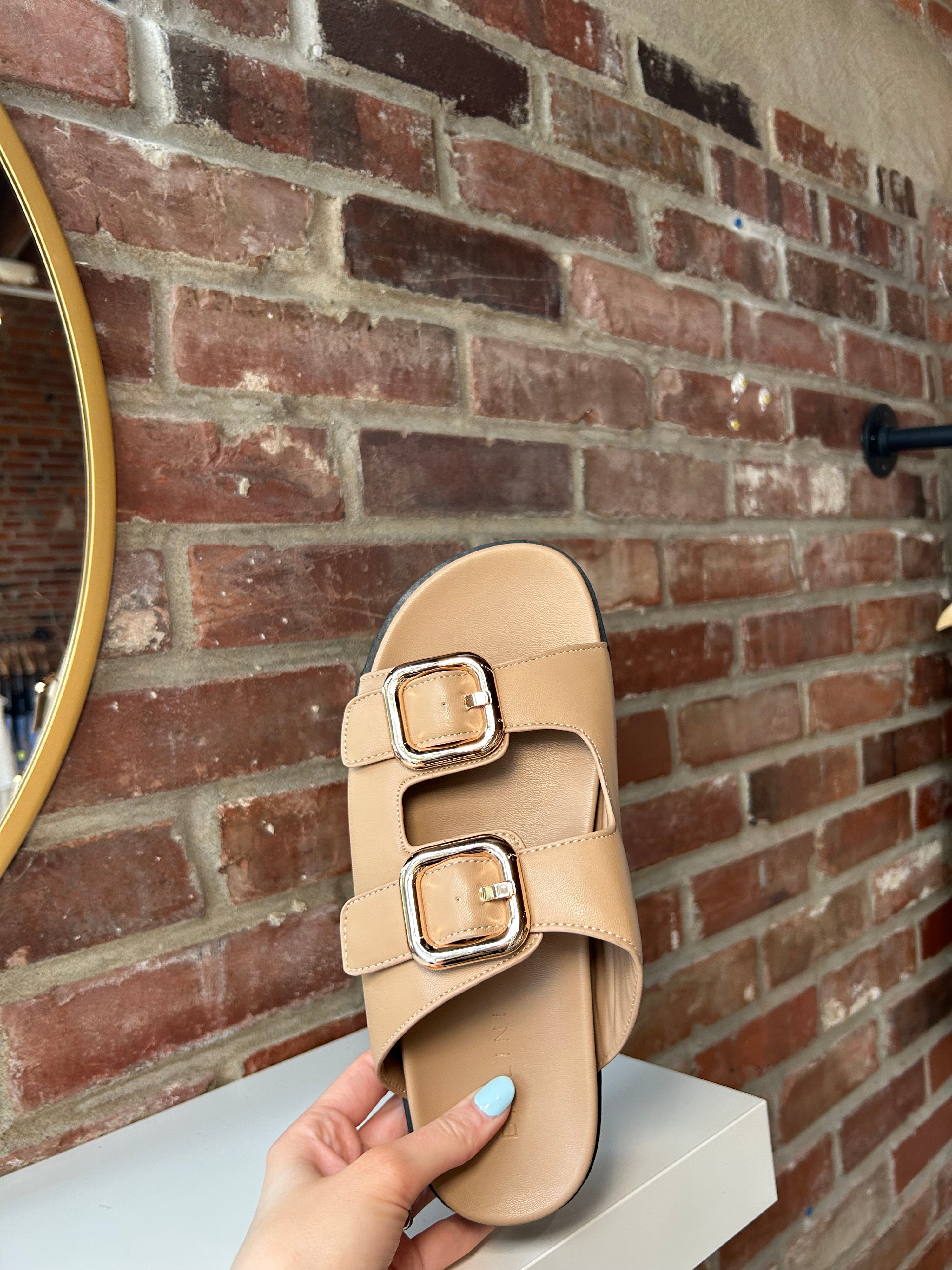 Brown flat sandal with good hardware buckle. Perfect for everyday wear.