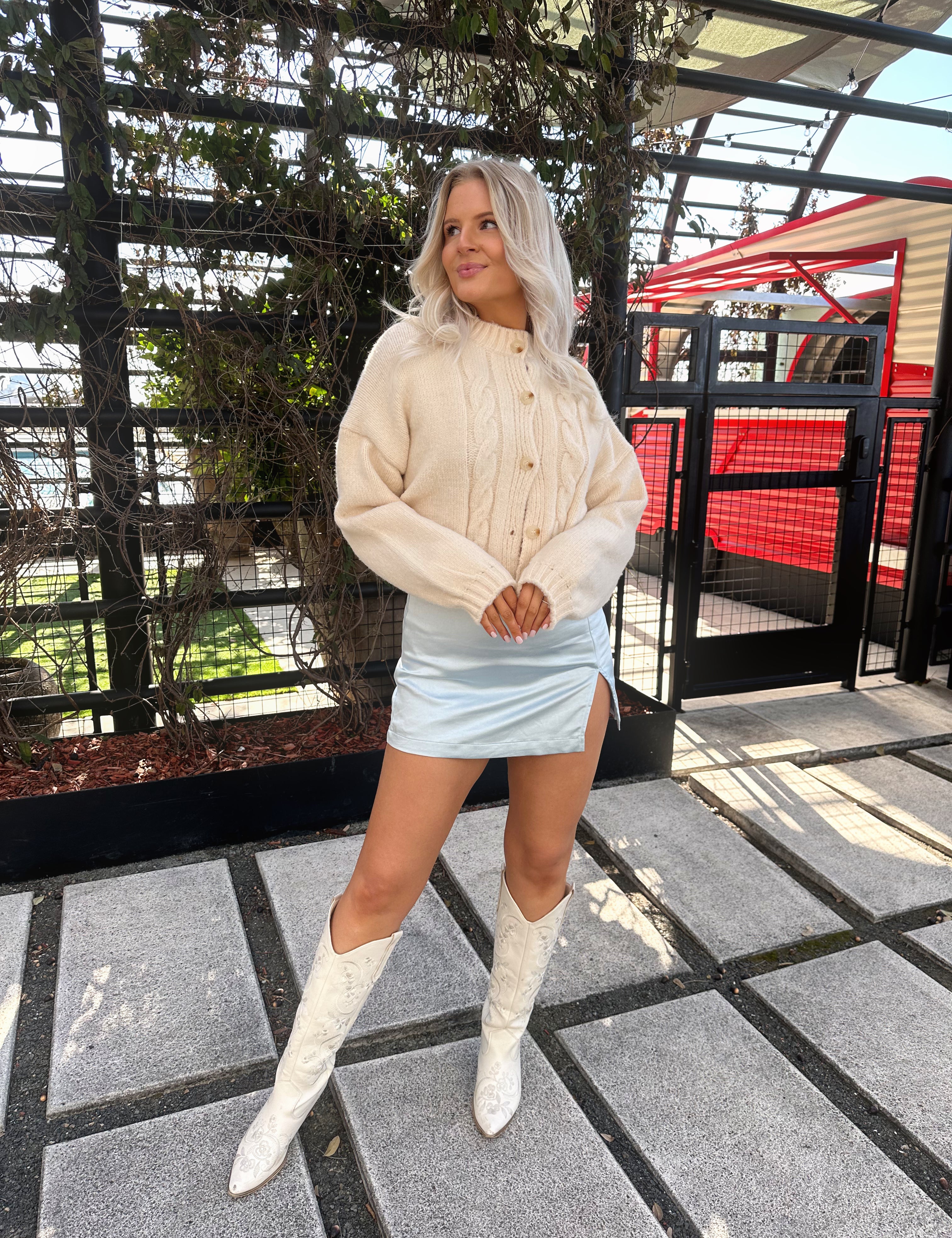 Baby blue satin mini skirt with side slit.