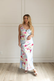 Blue satin maxi dress with pink floral pattern. Adjustable spaghetti straps and keyhole cutout. 