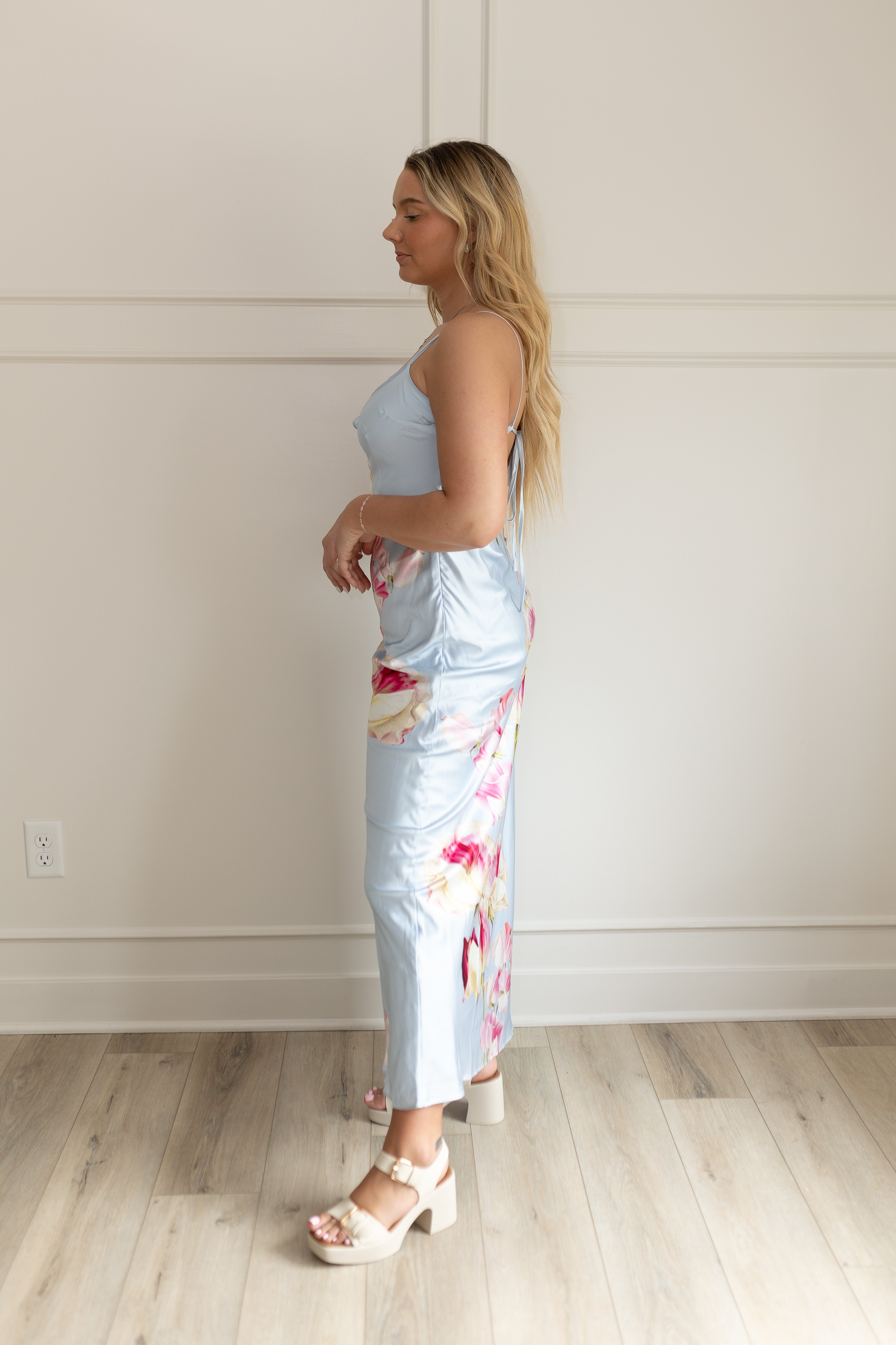Blue satin maxi dress with pink floral pattern. Adjustable spaghetti straps and keyhole cutout. 