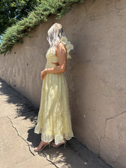 Light yellow midi dress with lace up corset back, and embroidery detailing. 