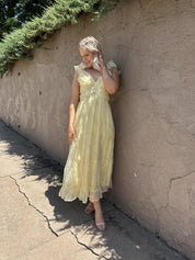 Light yellow midi dress with lace up corset back, and embroidery detailing. 