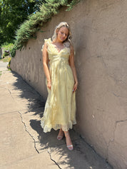 Light yellow midi dress with lace up corset back, and embroidery detailing. 