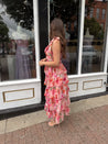 Pink floral tiered midi dress with ruffle layers and tie shoulder straps