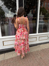 Pink floral tiered midi dress with ruffle layers and tie shoulder straps