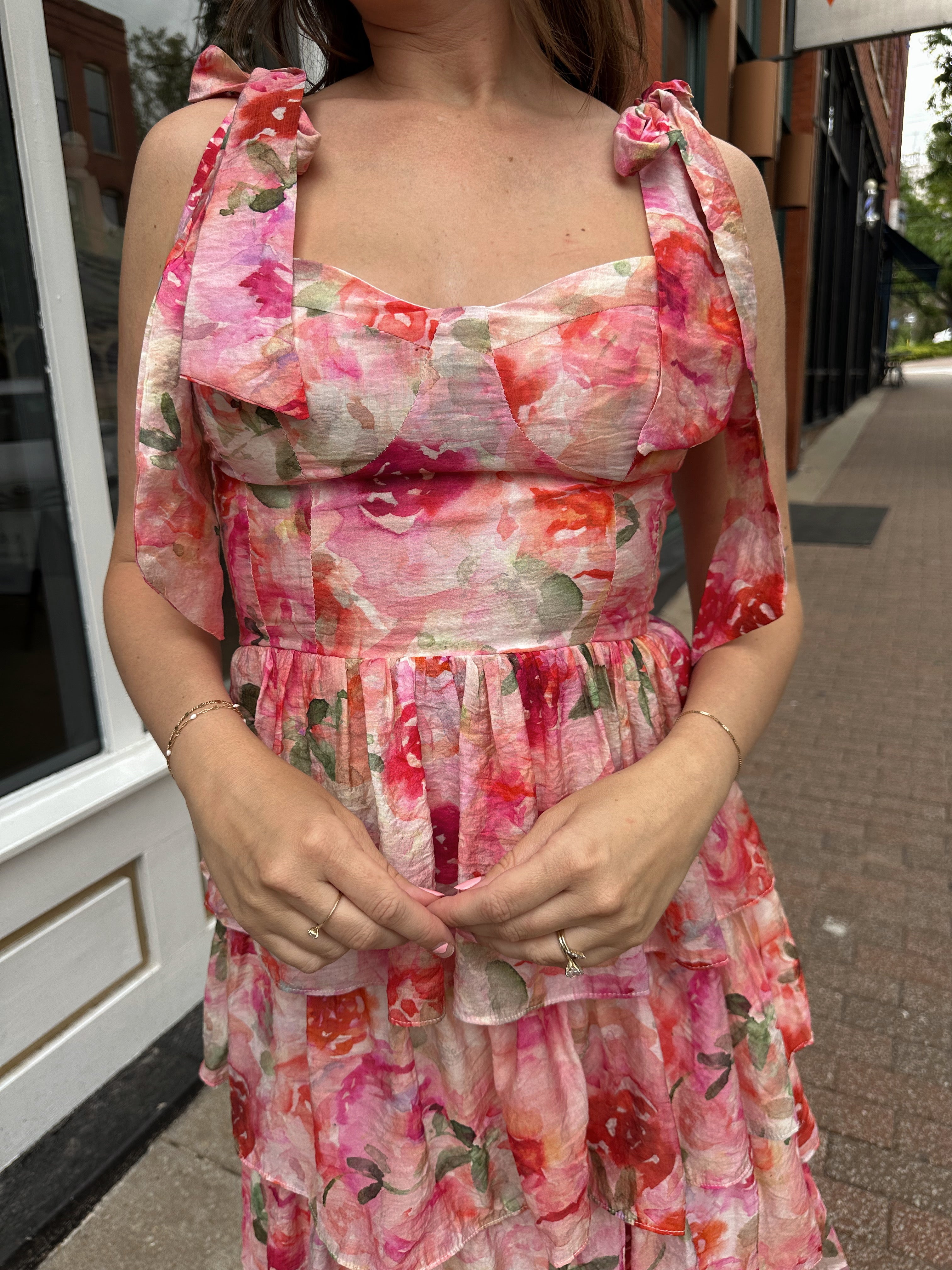 Pink floral tiered midi dress with ruffle layers and tie shoulder straps