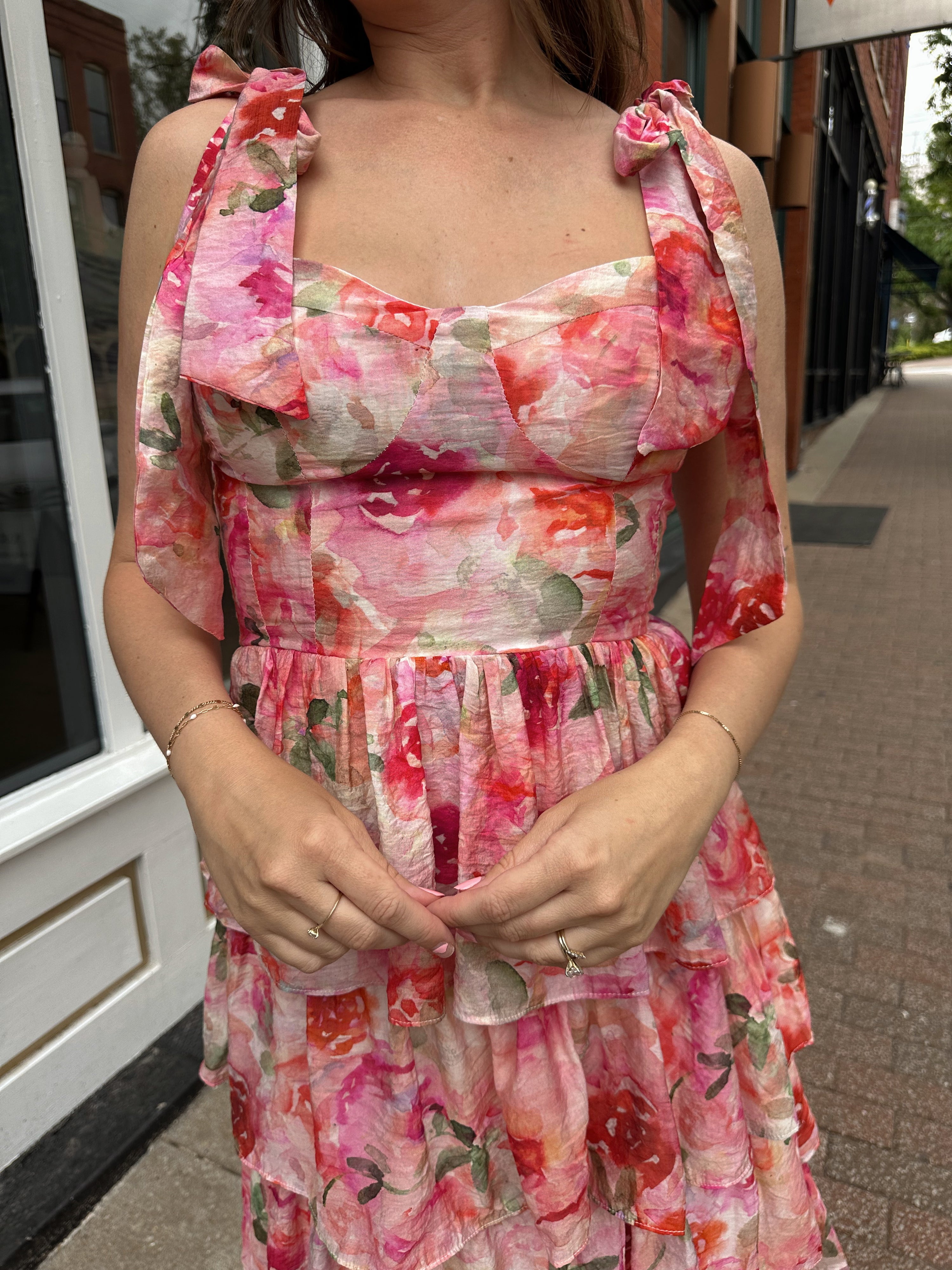 Pink floral tiered midi dress with ruffle layers and tie shoulder straps