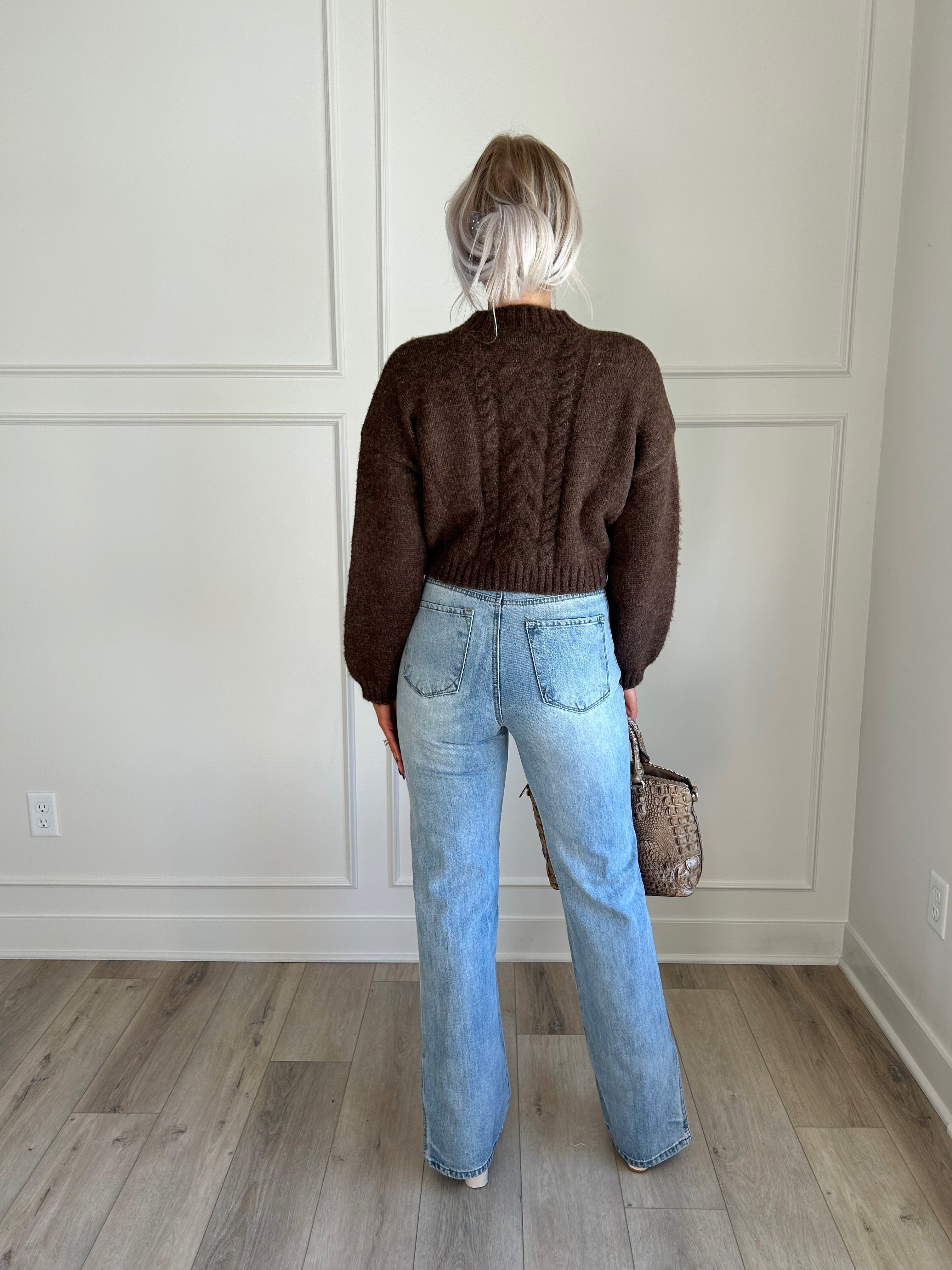 Brown cropped cable knit sweater with button-up front and cozy fit.