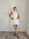 White bubble hem dress with black bow embroidery and smocked bodice.