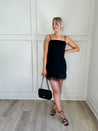 Black feather hem dress.