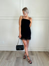 Black feather hem dress.