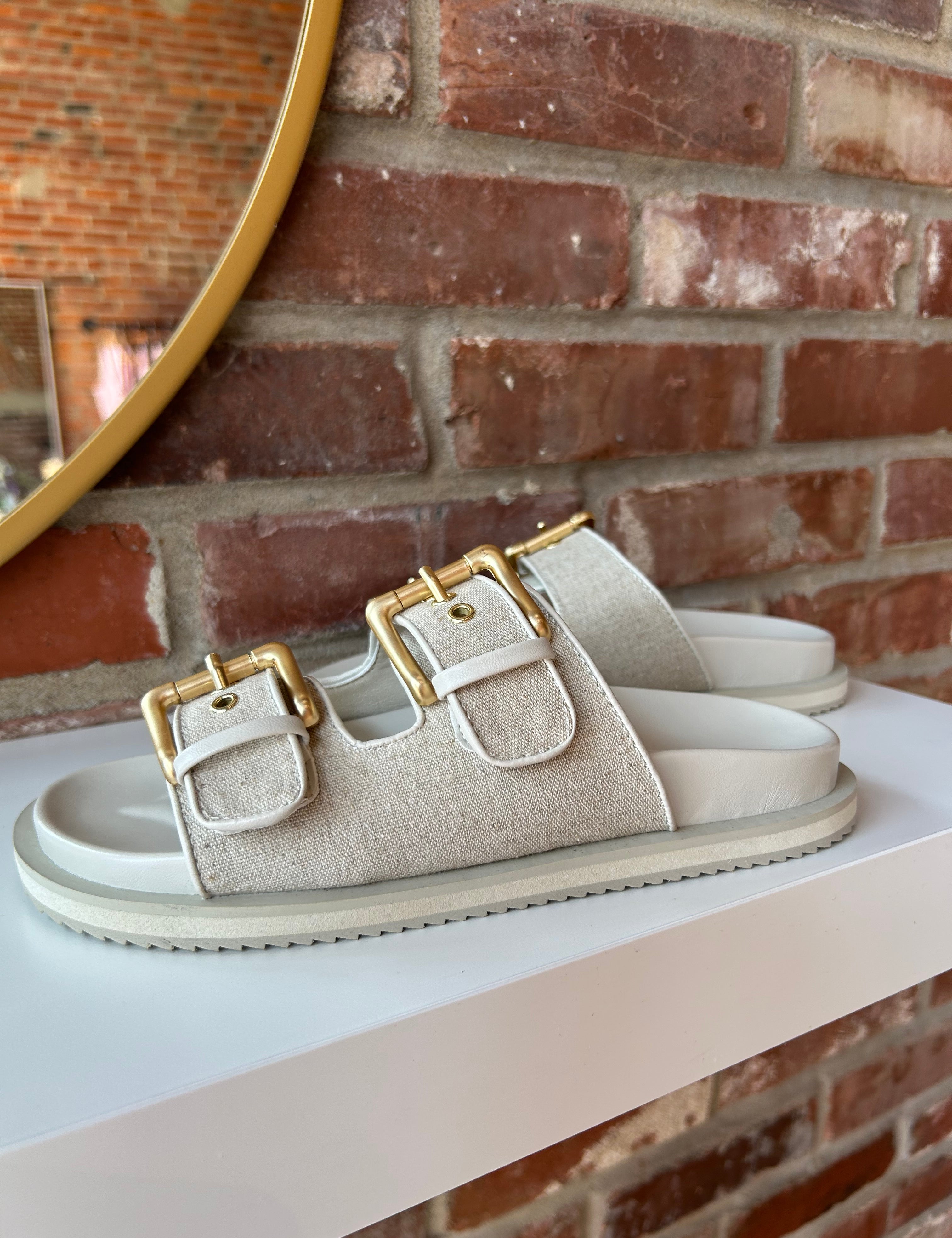 Billini Lilia Linen Sandal with gold double buckles, linen-textured straps, and a cushioned sole for a stylish and comfortable fit.