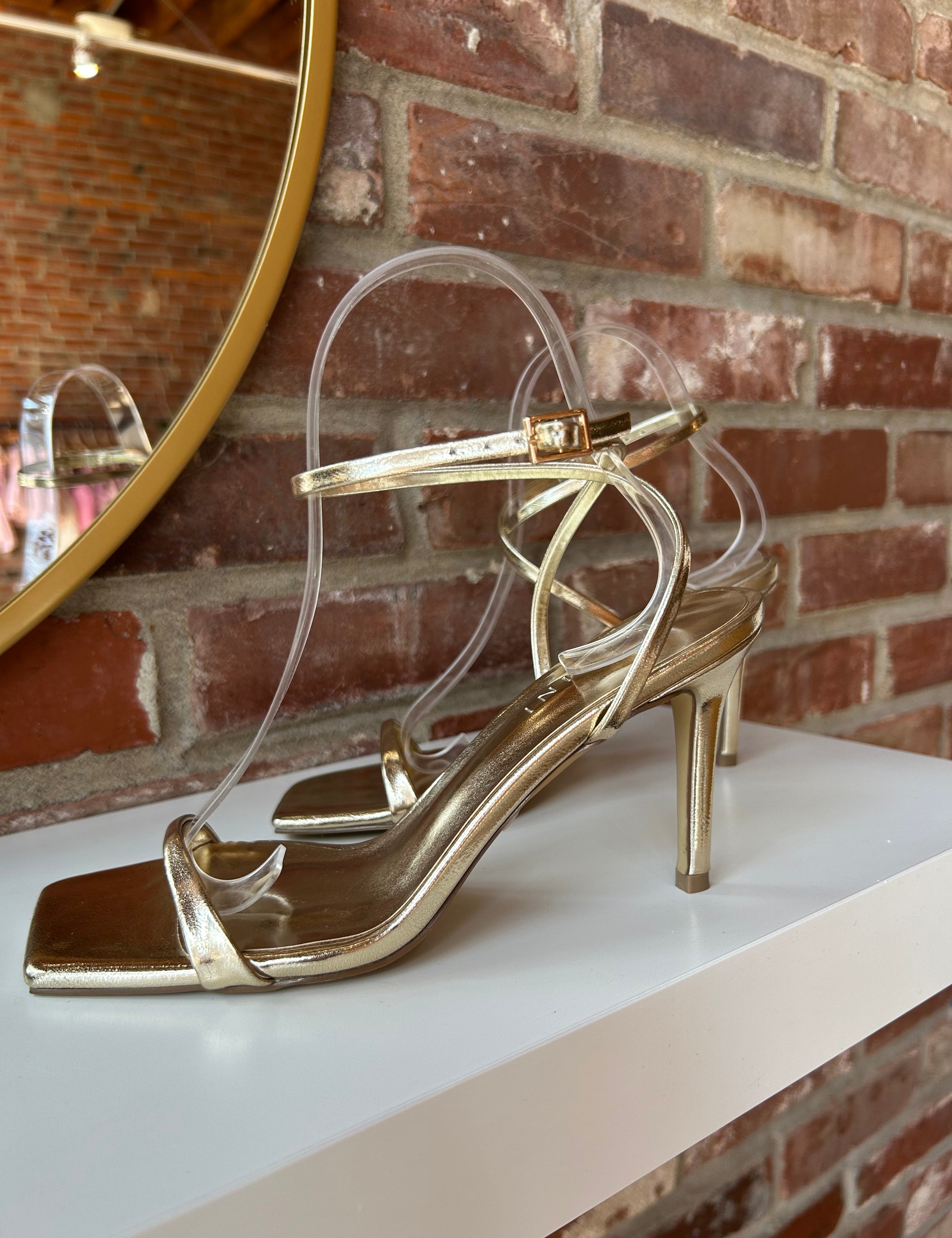 Alani Gold Strappy Heel with a metallic finish, slim straps, and a stiletto heel for an elegant and modern style.