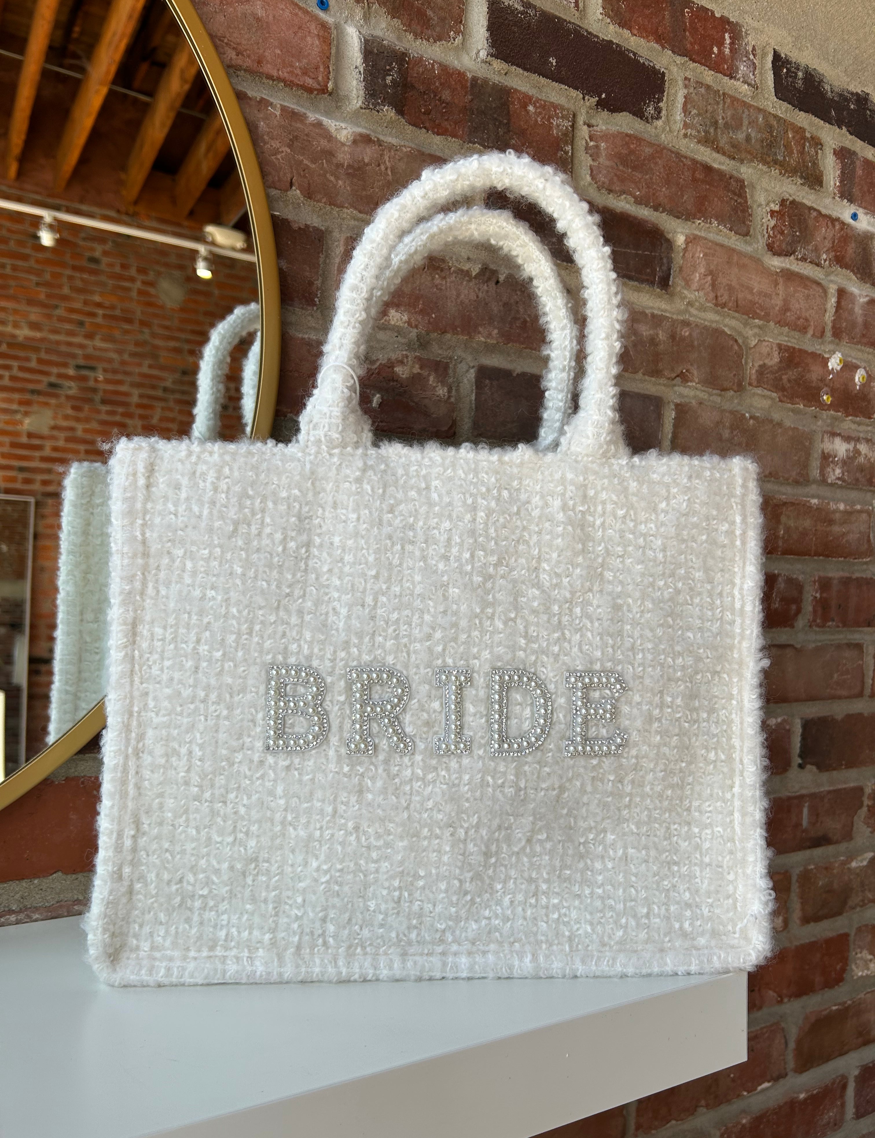Bride Tweed Tote Bag with pearl-embellished lettering, soft textured fabric, and durable handles for a stylish bridal look.