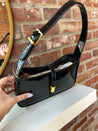 Black patent leather shoulder bag with gold hardware. Perfect for everyday use