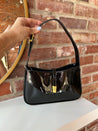 Black patent leather shoulder bag with gold hardware. Perfect for everyday use