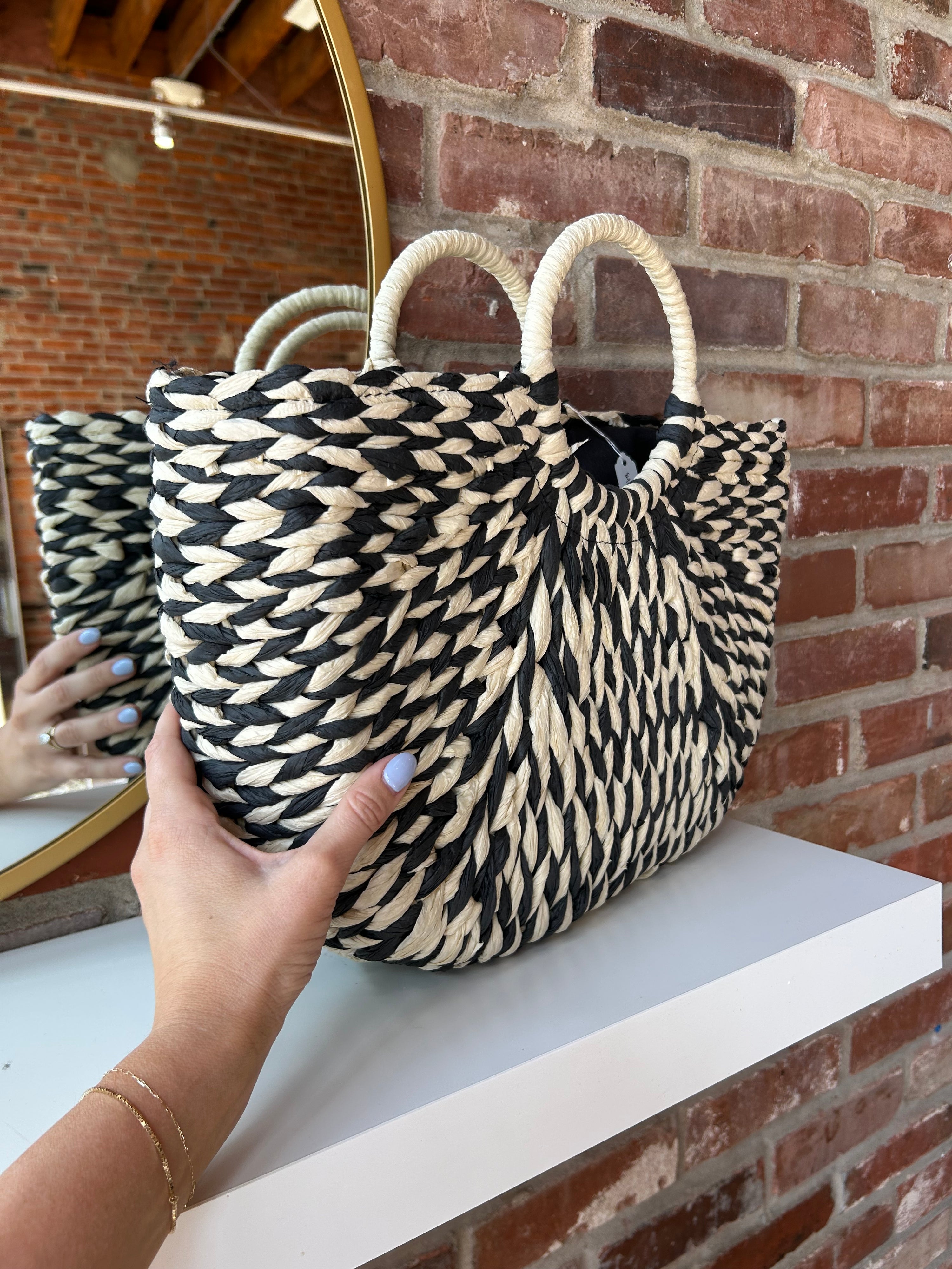 Black and tan straw woven tote bag. Perfect for vacation or carrying all summer. 
