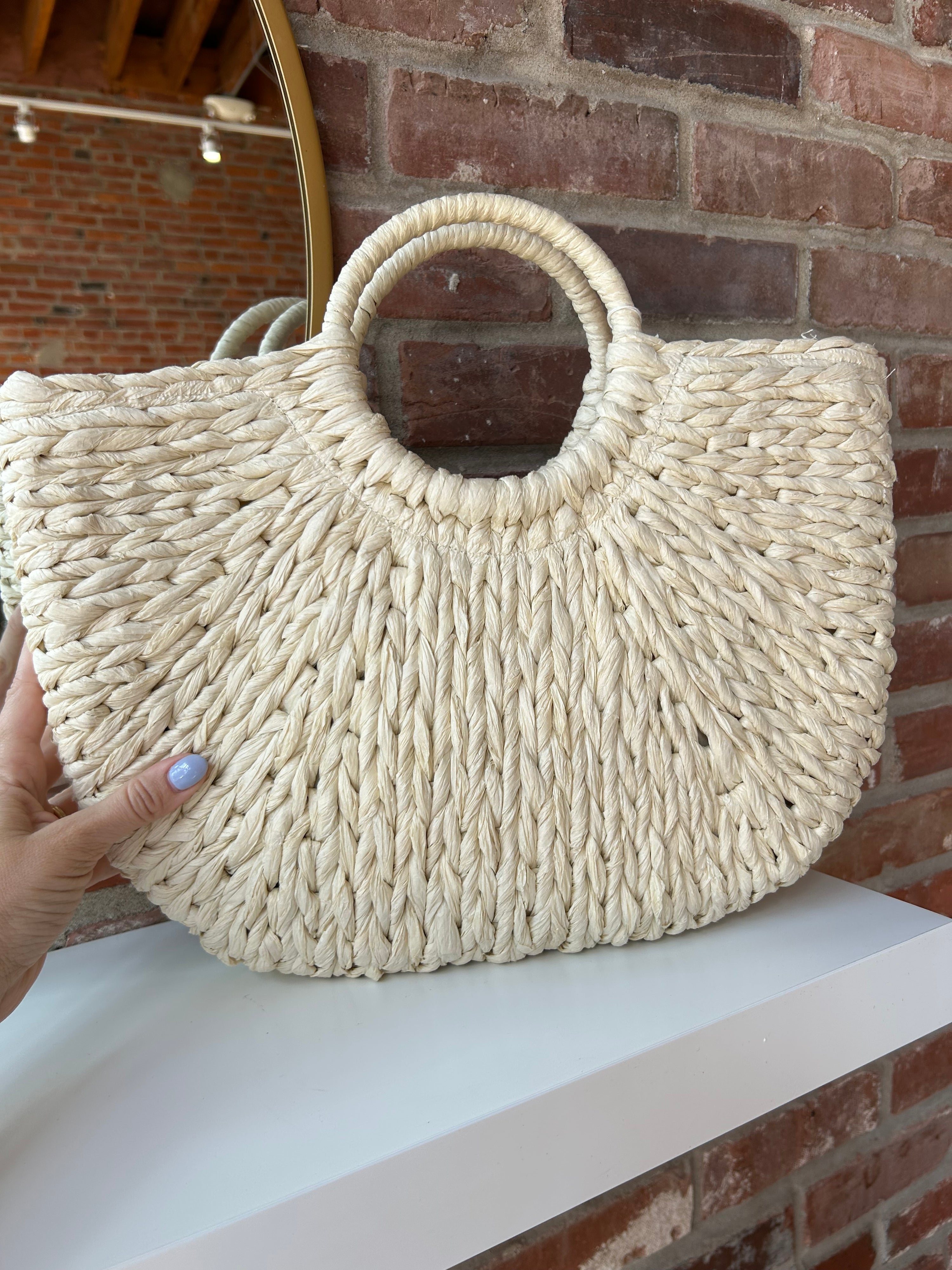 Beige straw woven tote bag. Perfect for vacation or carrying all summer. 