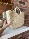 Beige straw woven tote bag. Perfect for vacation or carrying all summer. 
