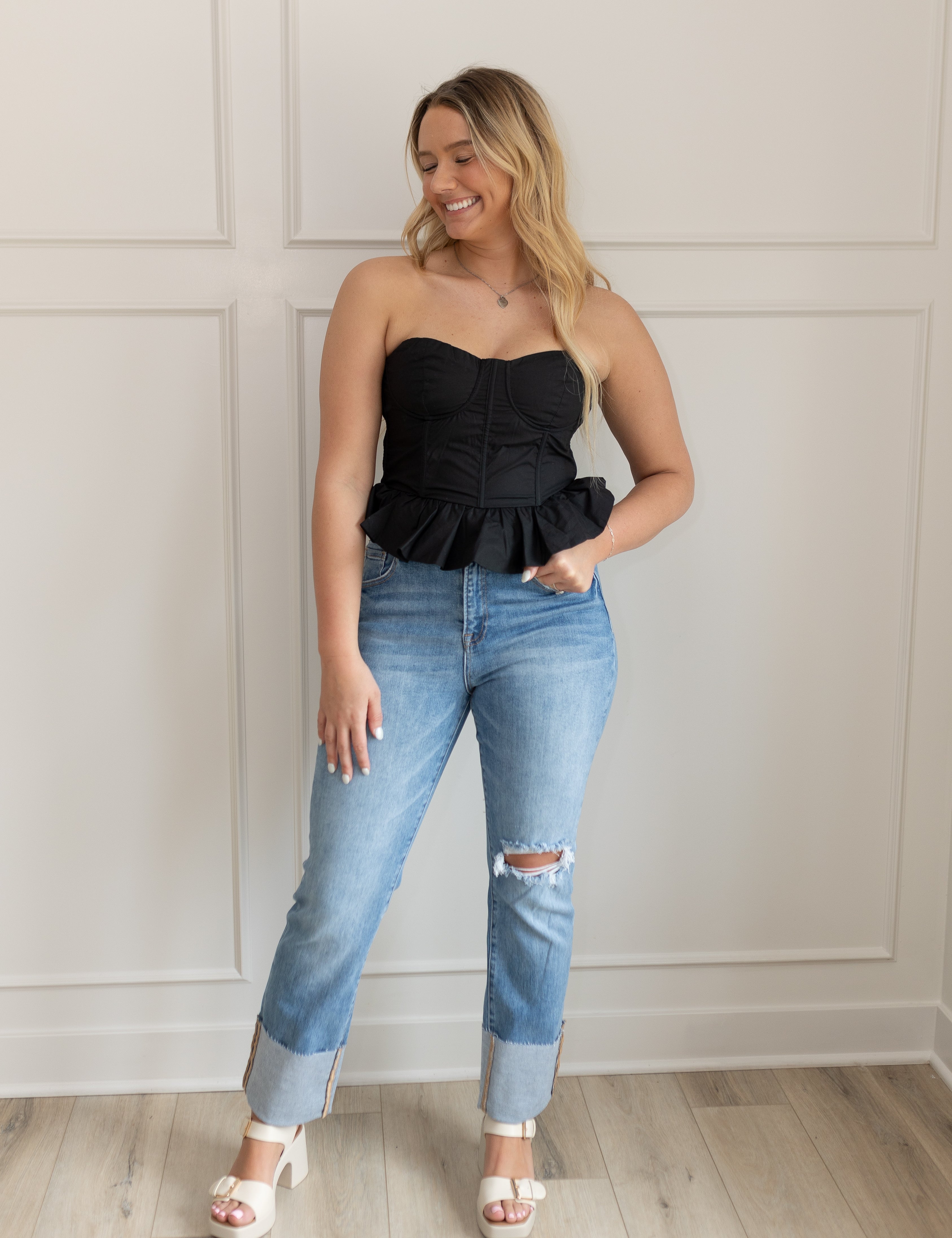 Black strapless corset top with peplum hem and fitted bodice