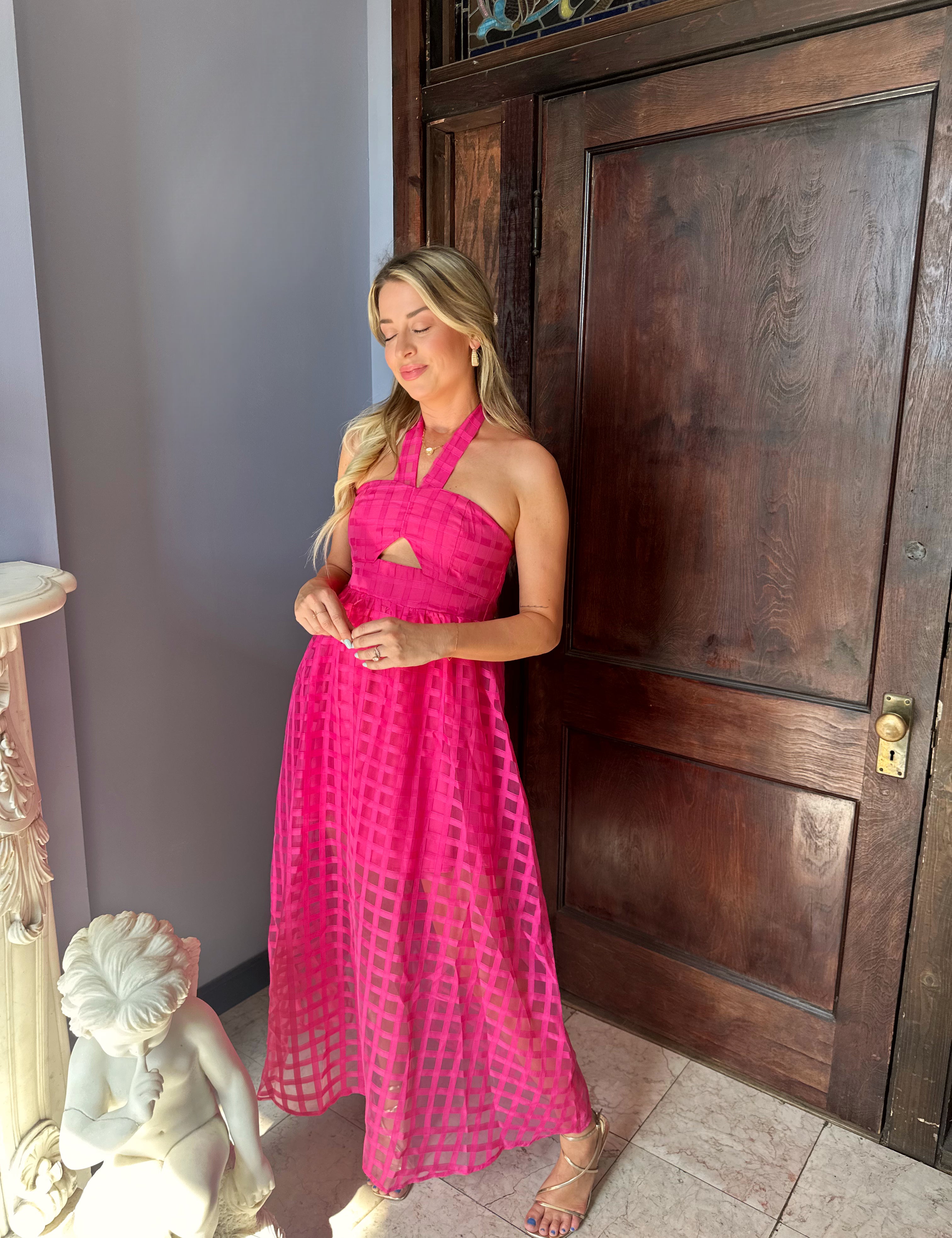 Hot pink checkered halter maxi dress with a cutout and flowy skirt