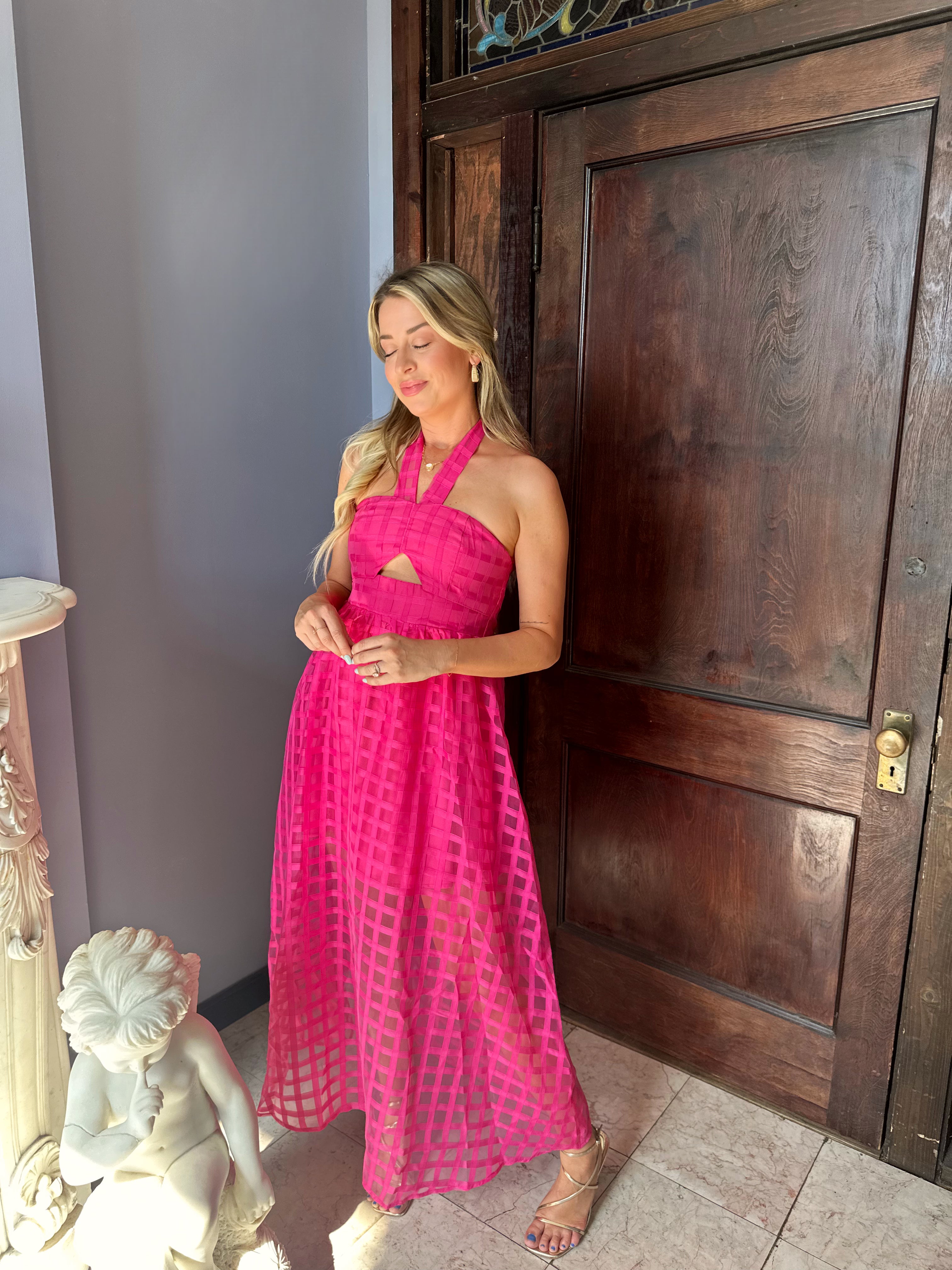 Hot pink checkered halter maxi dress with a cutout and flowy skirt