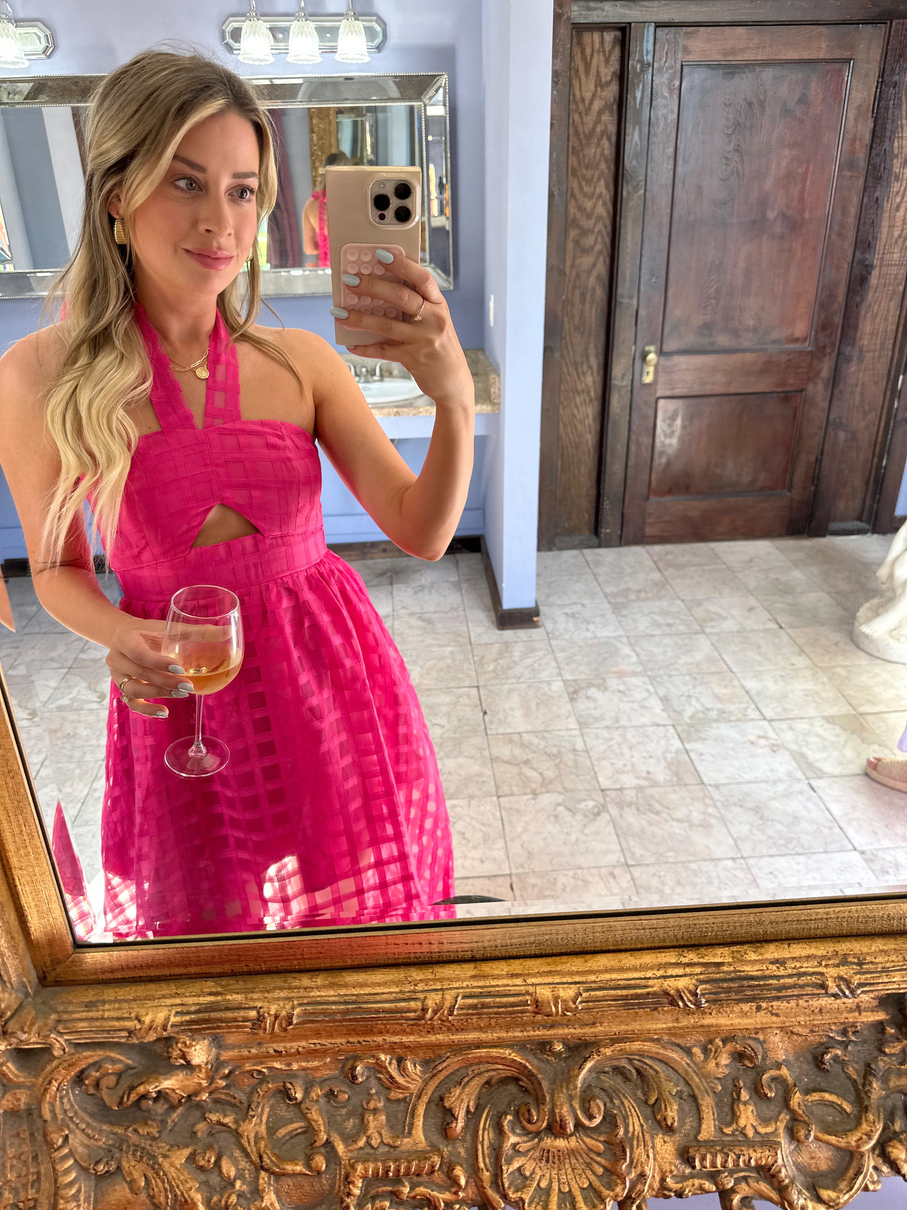 Hot pink checkered halter maxi dress with a cutout and flowy skirt
