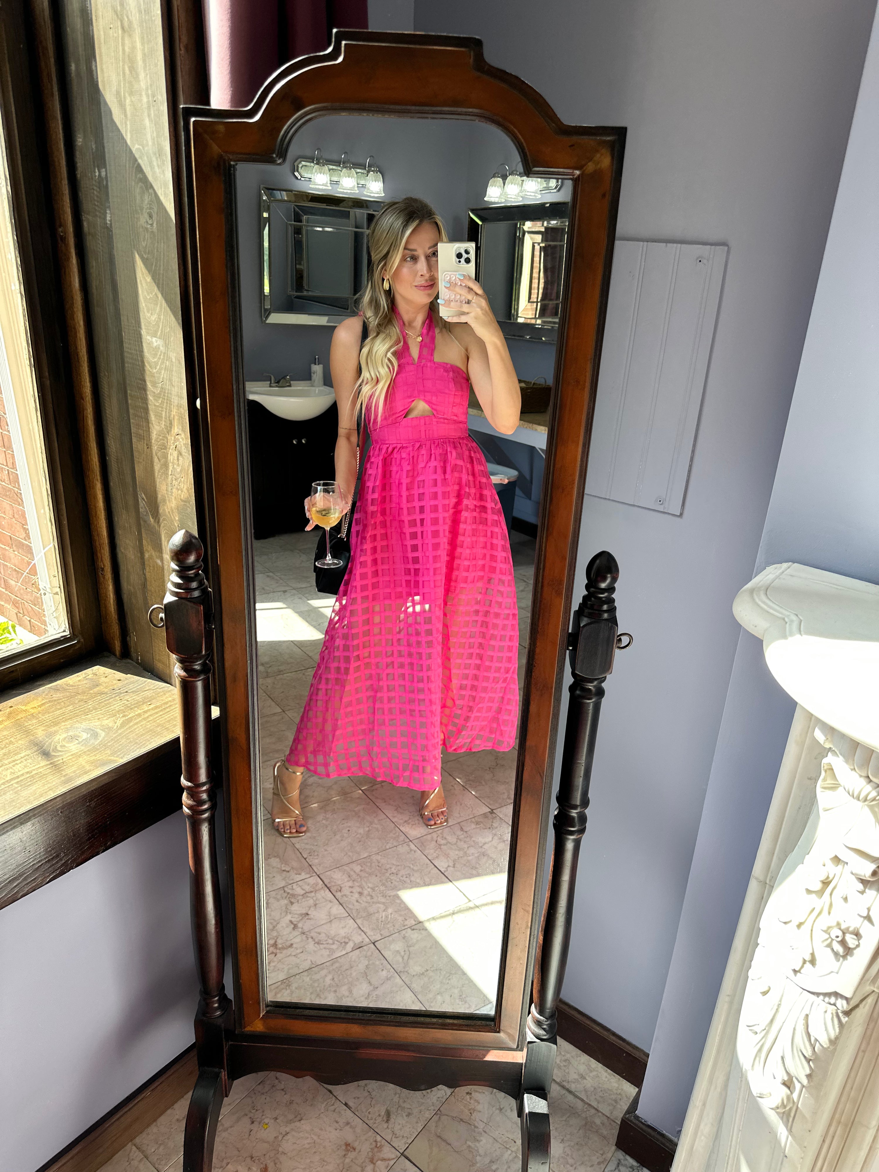 Hot pink checkered halter maxi dress with a cutout and flowy skirt