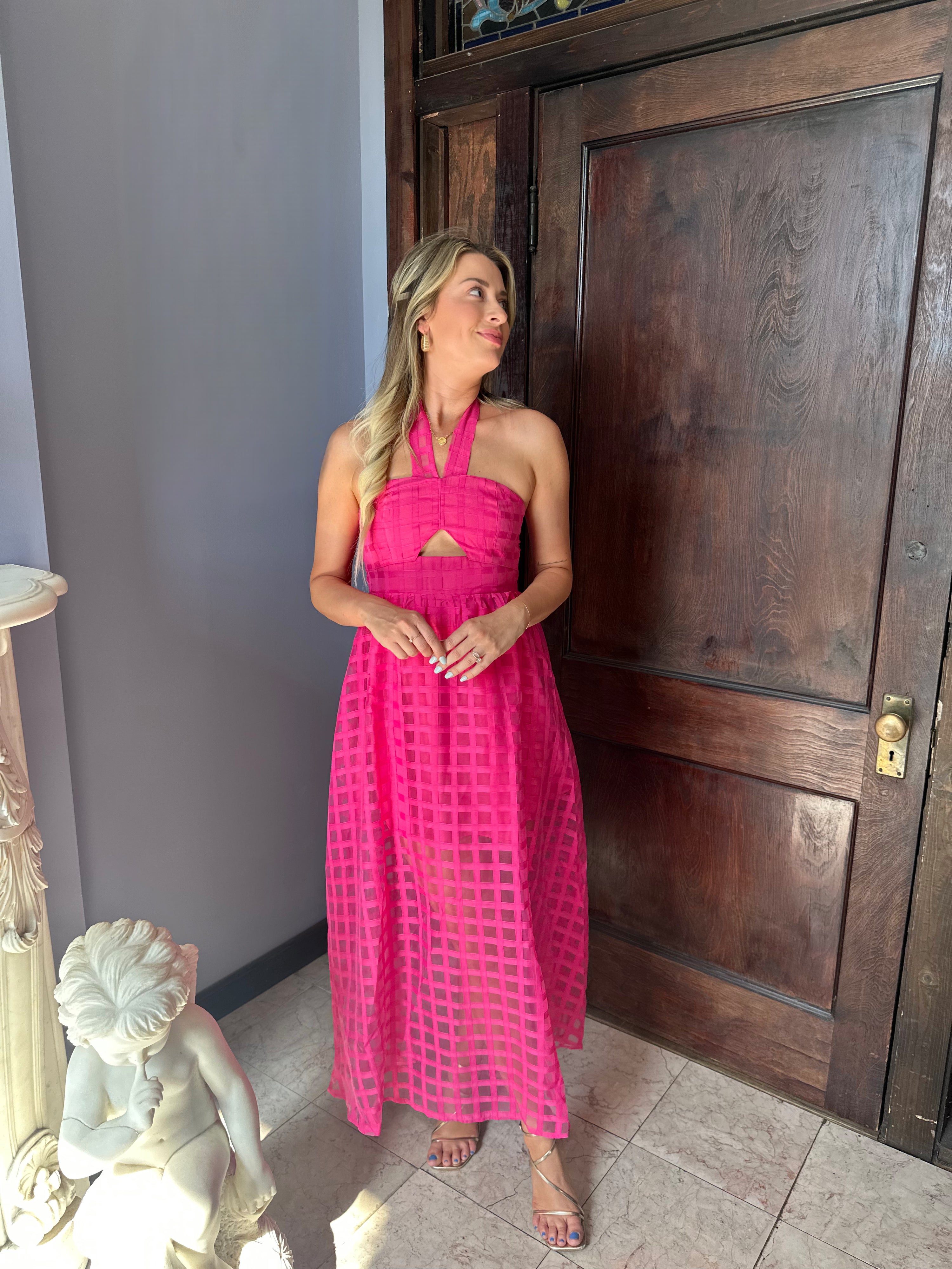 Hot pink checkered halter maxi dress with a cutout and flowy skirt