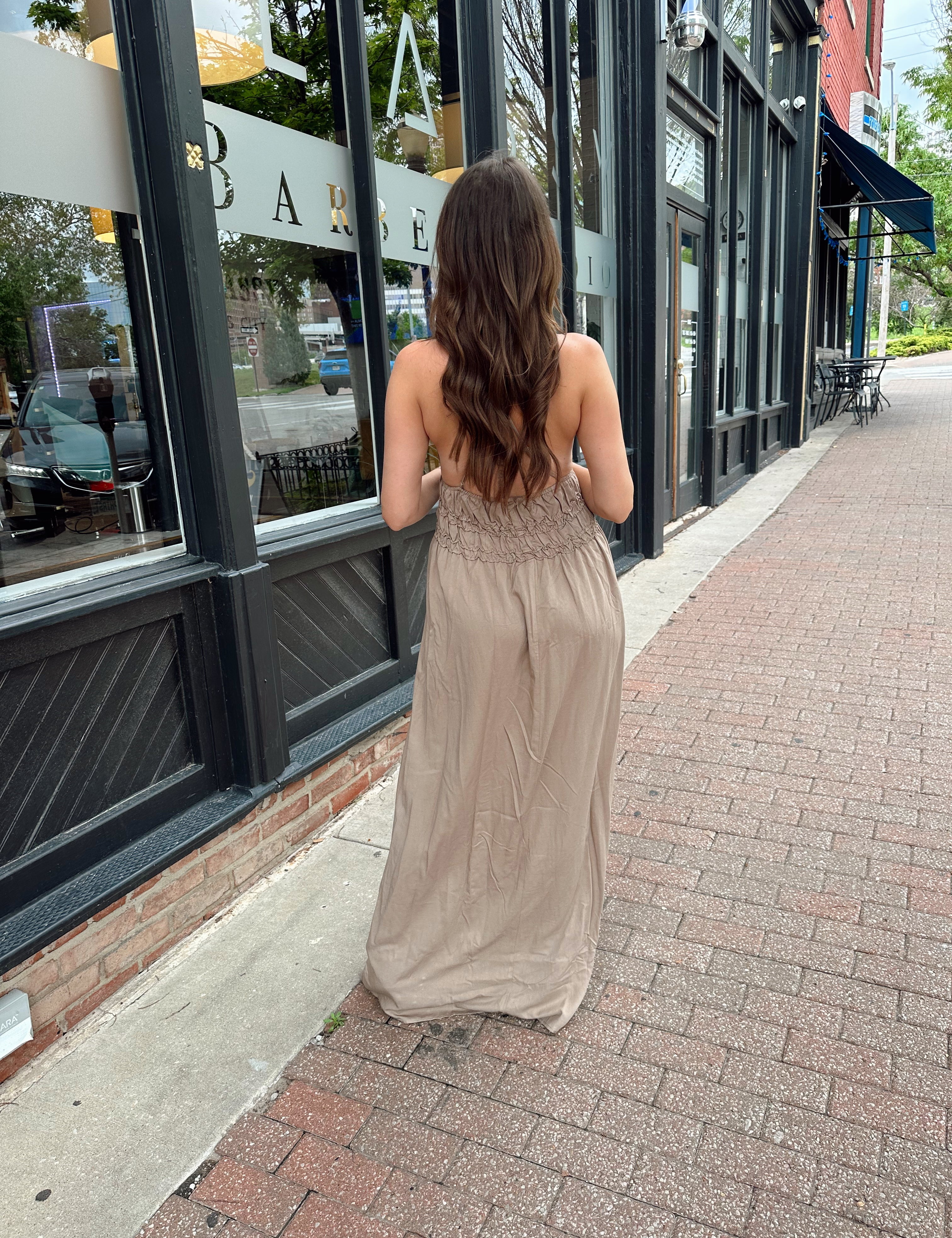 Beige ruched maxi dress with plunging neckline and open crisscross back detail