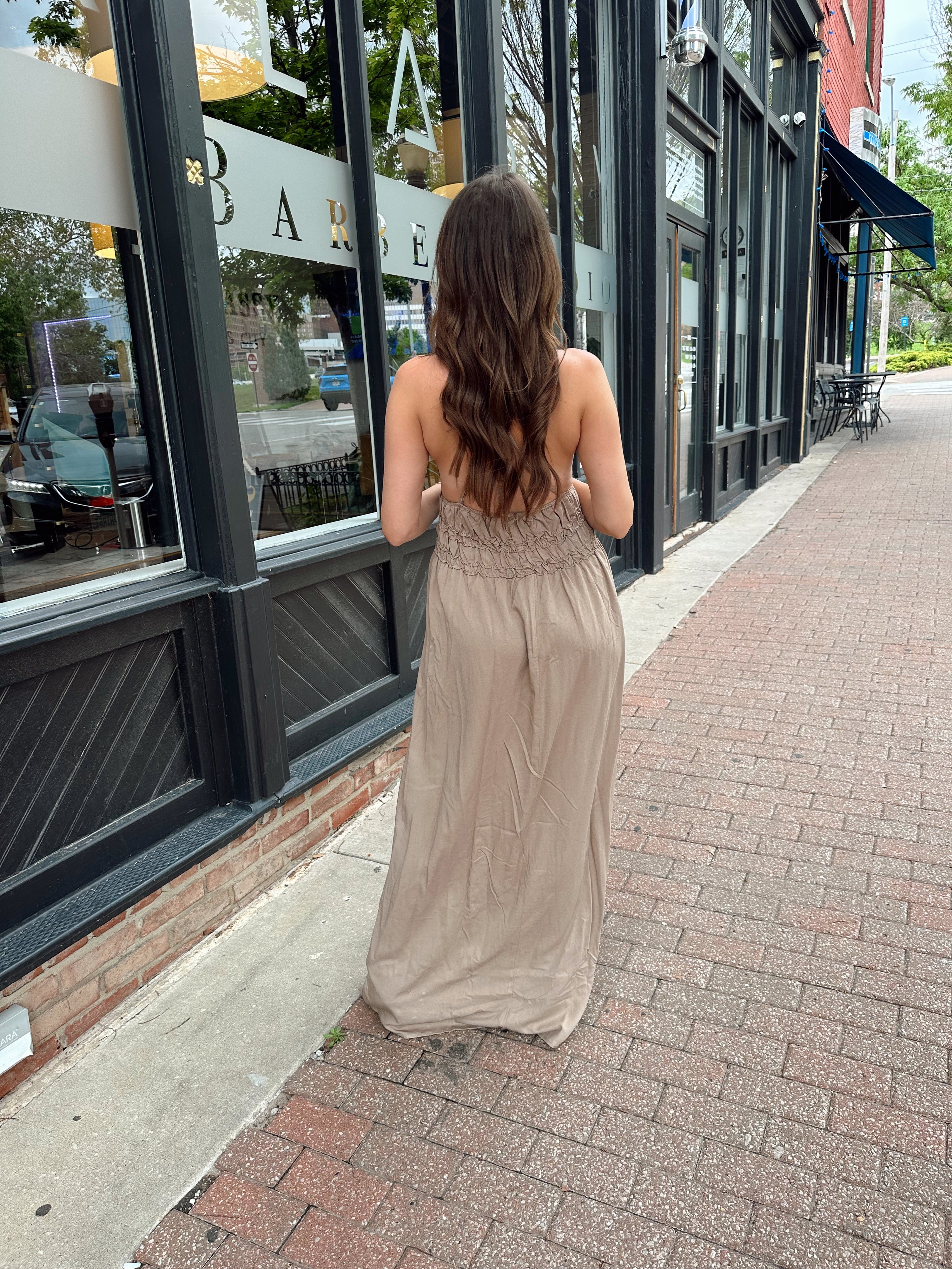 Beige ruched maxi dress with plunging neckline and open crisscross back detail