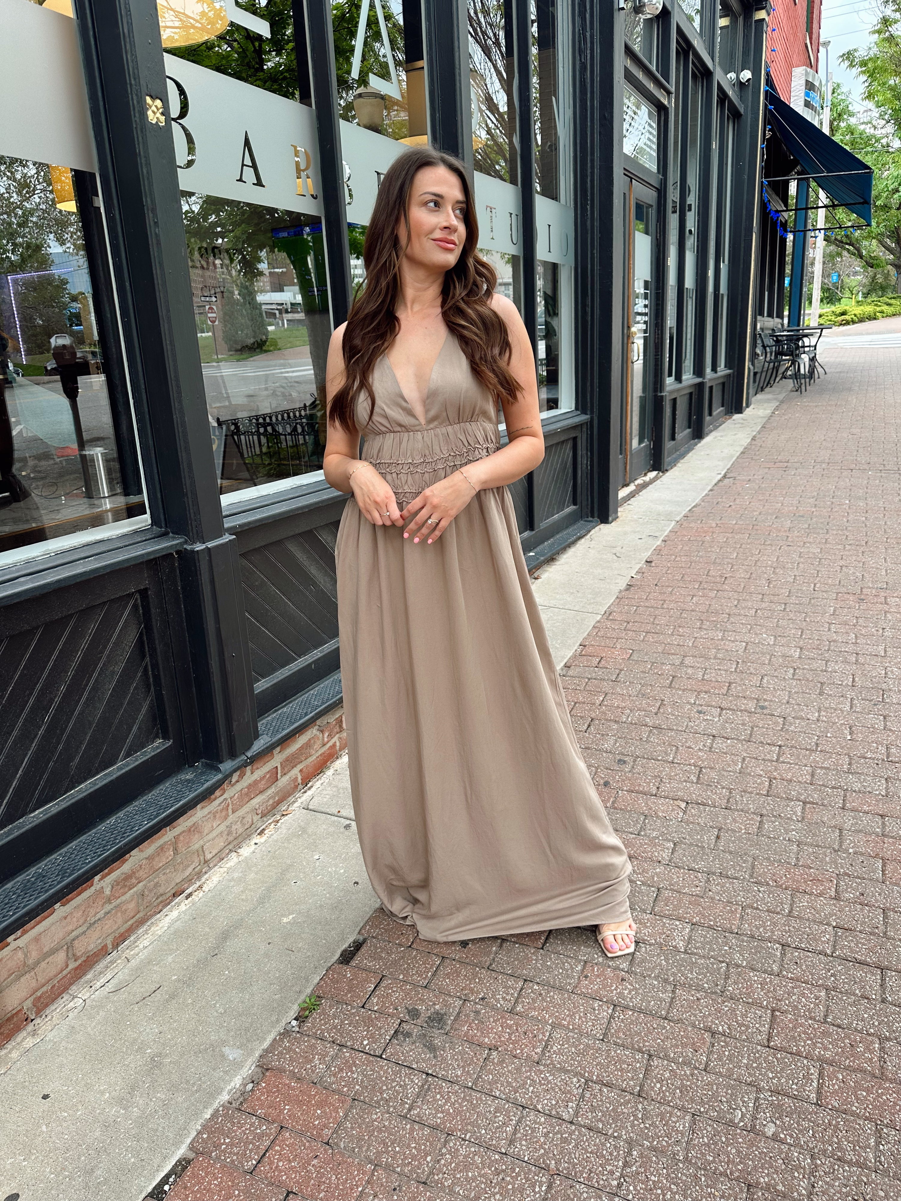Beige ruched maxi dress with plunging neckline and open crisscross back detail