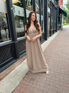 Beige ruched maxi dress with plunging neckline and open crisscross back detail