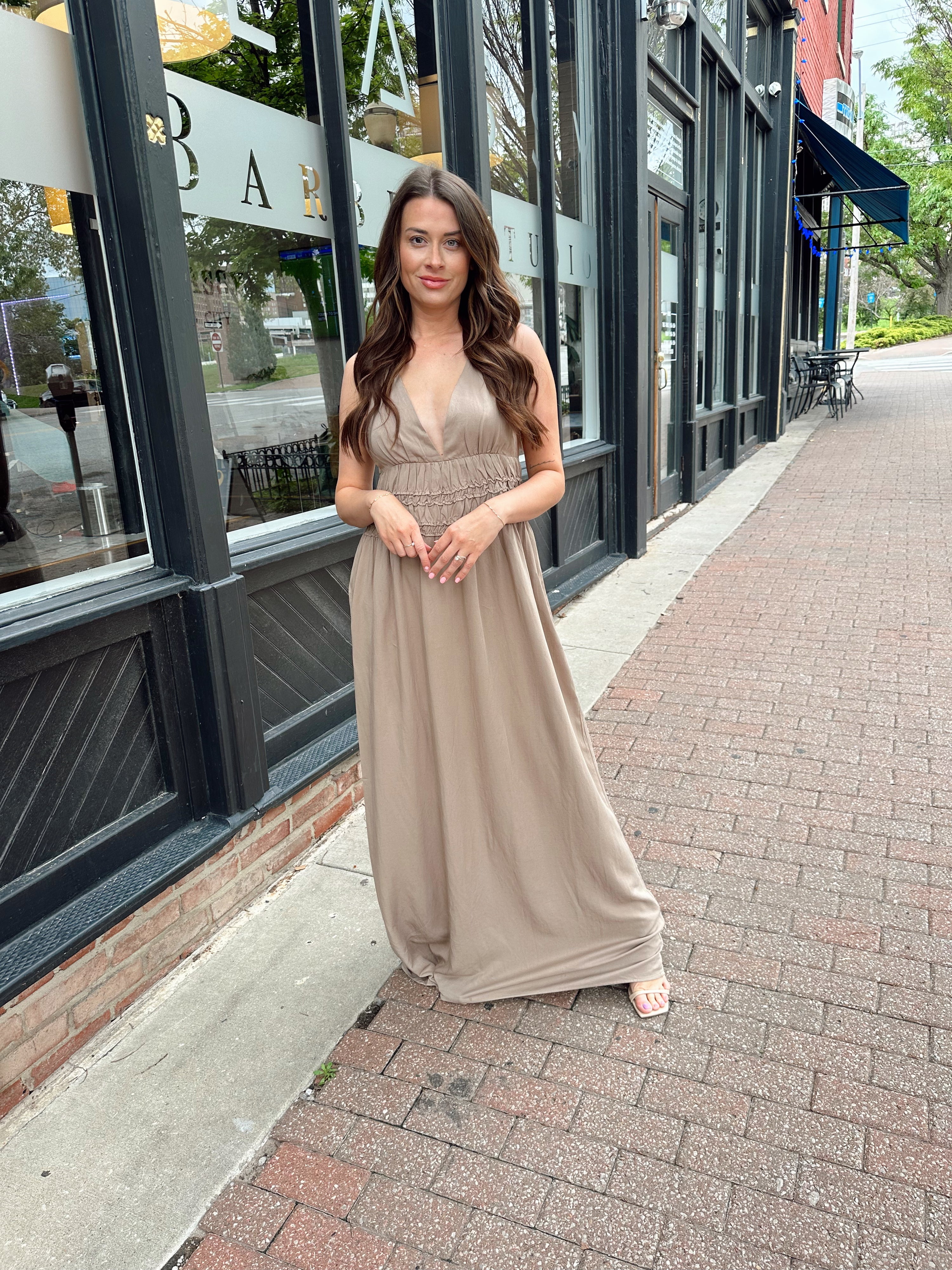 Beige ruched maxi dress with plunging neckline and open crisscross back detail
