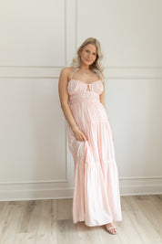Pink ruched maxi dress with strappy back and tiered flowy skirt