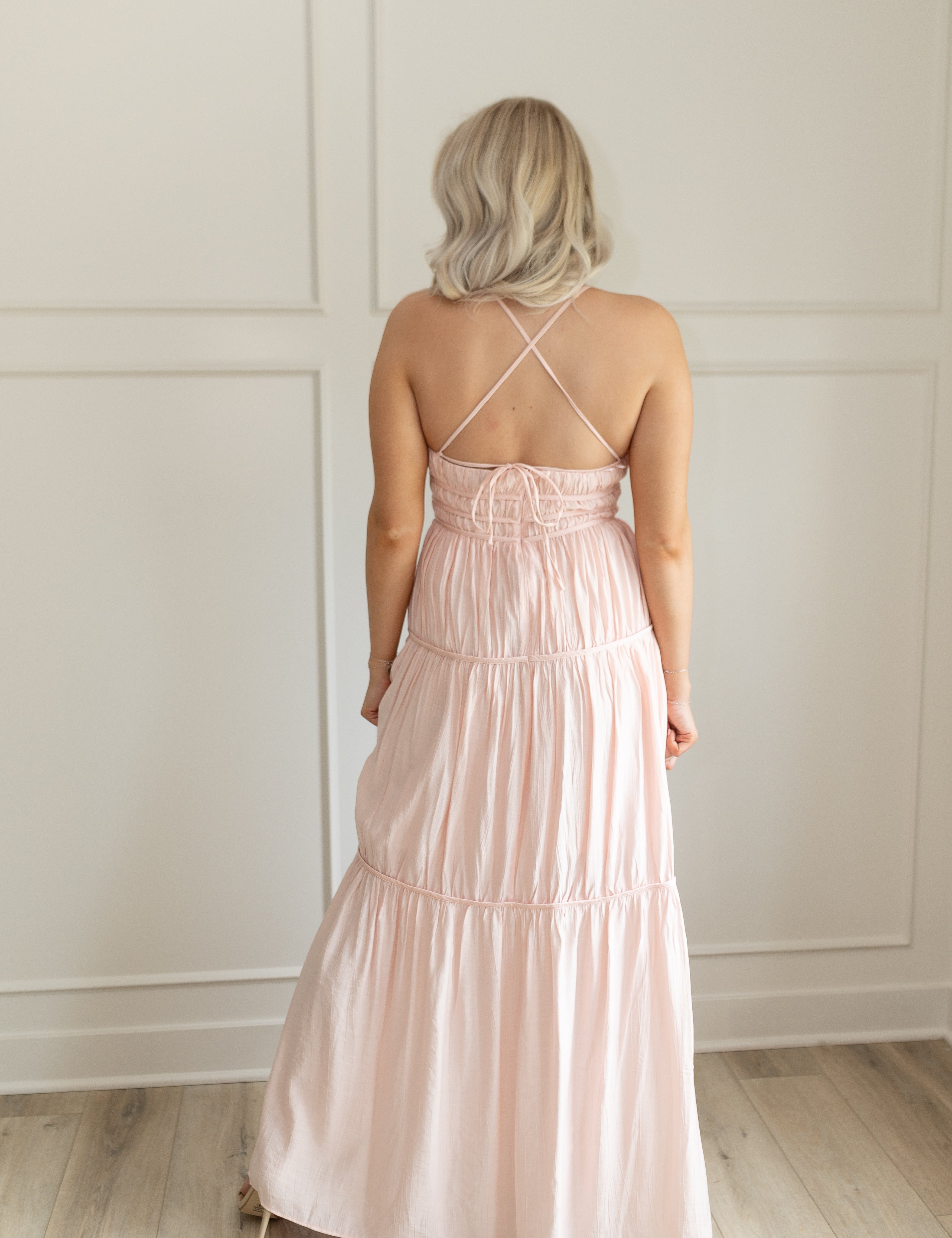 Pink ruched maxi dress with strappy back and tiered flowy skirt