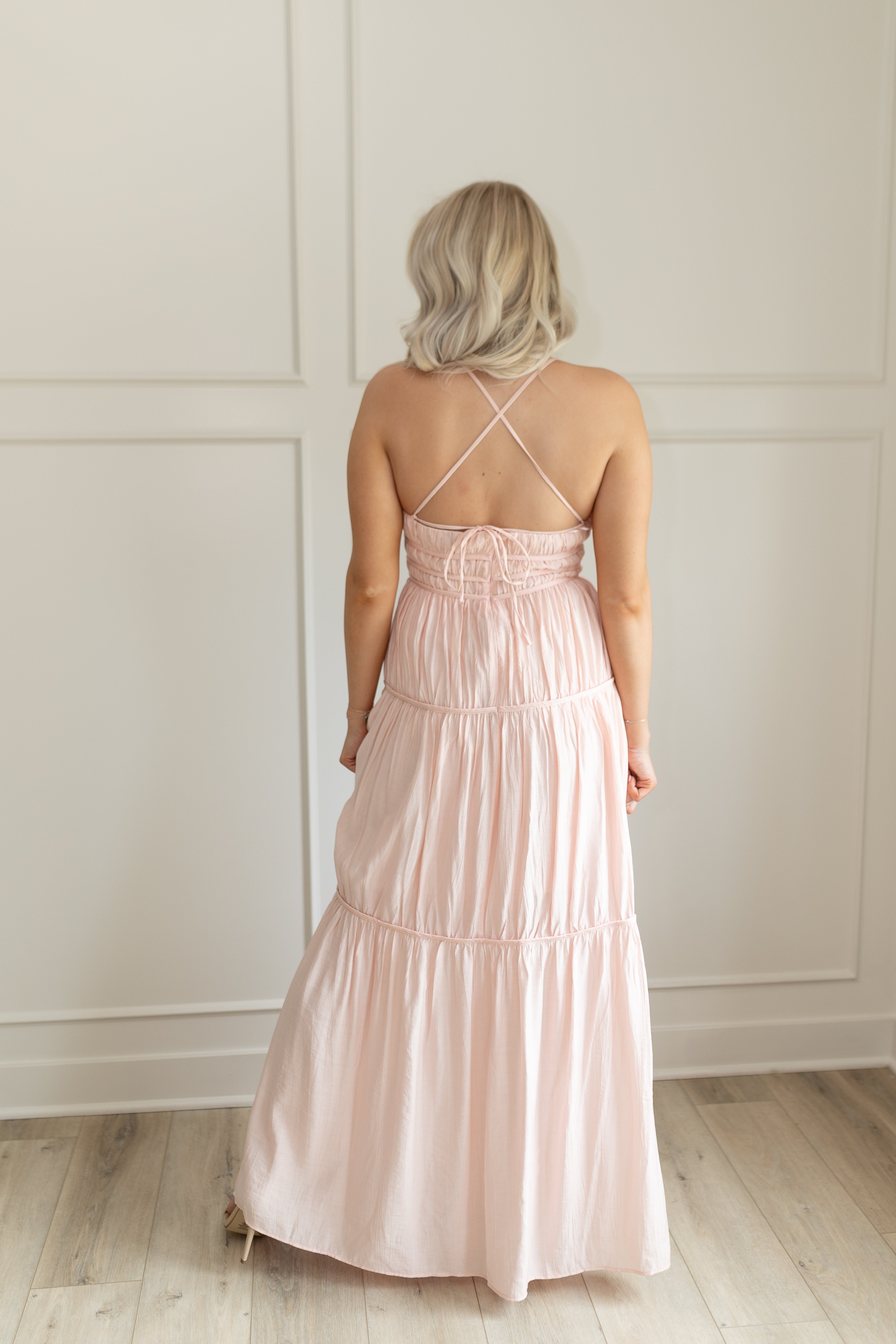 Pink ruched maxi dress with strappy back and tiered flowy skirt