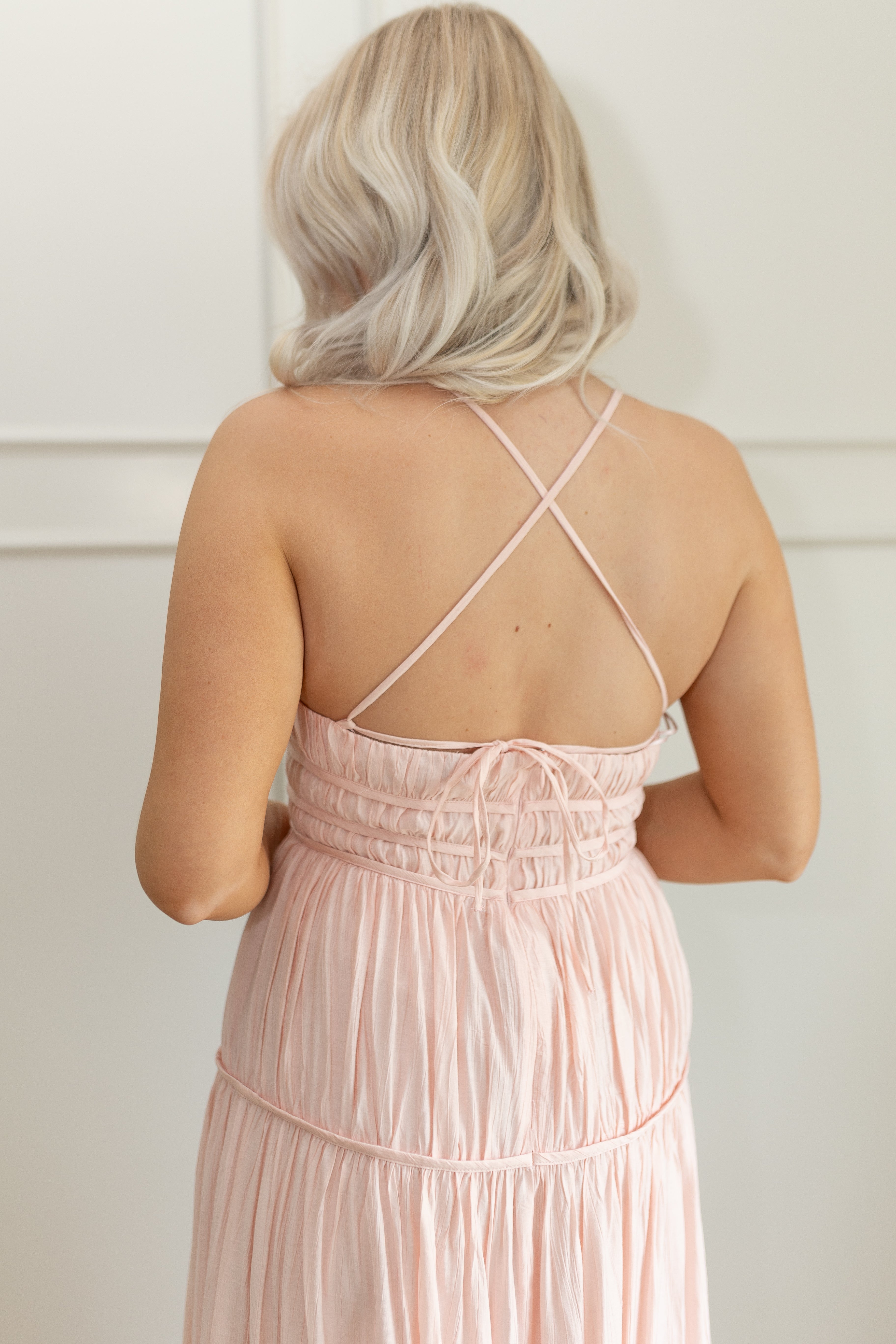Pink ruched maxi dress with strappy back and tiered flowy skirt