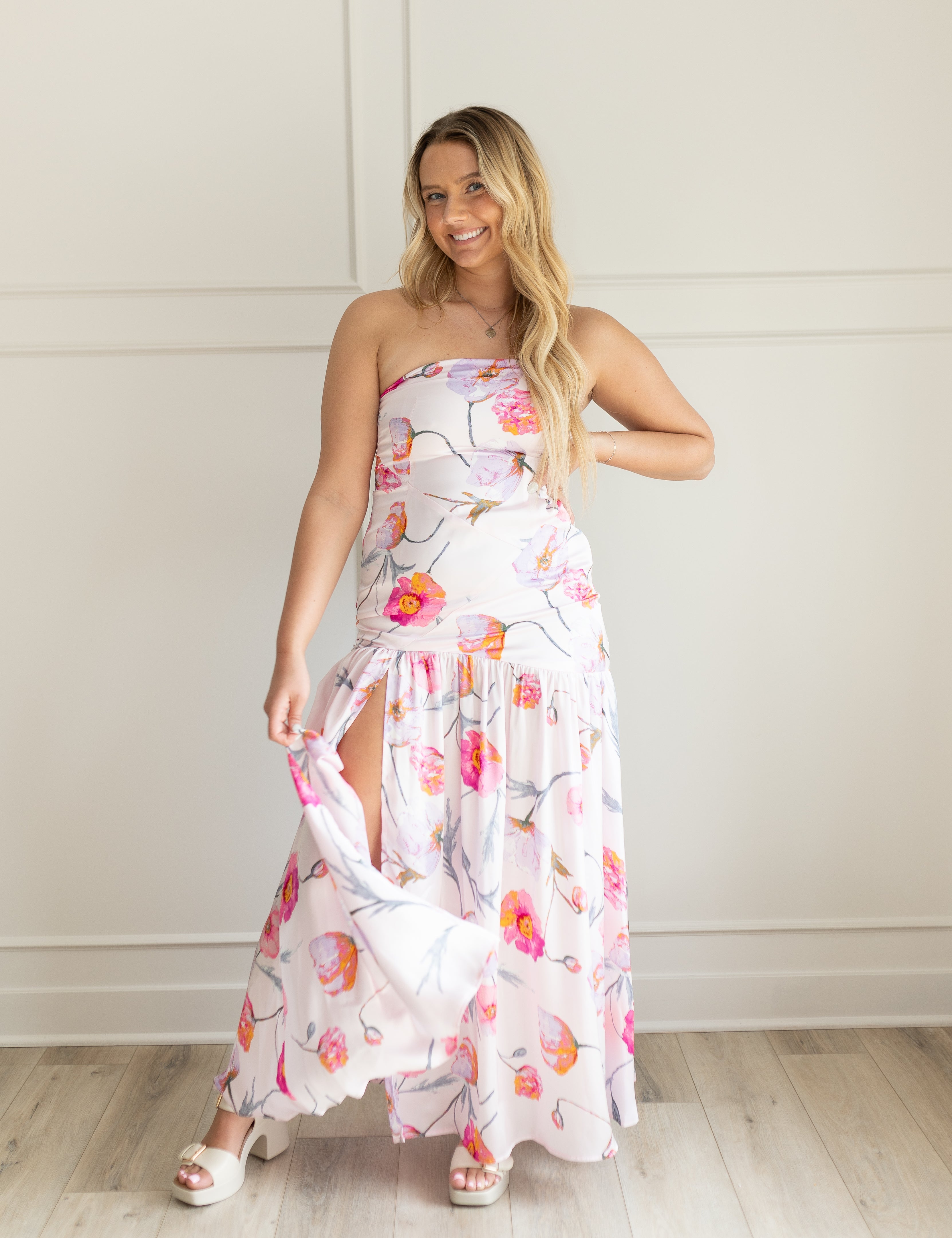 Pink strapless floral satin maxi dress with slit up the side. 