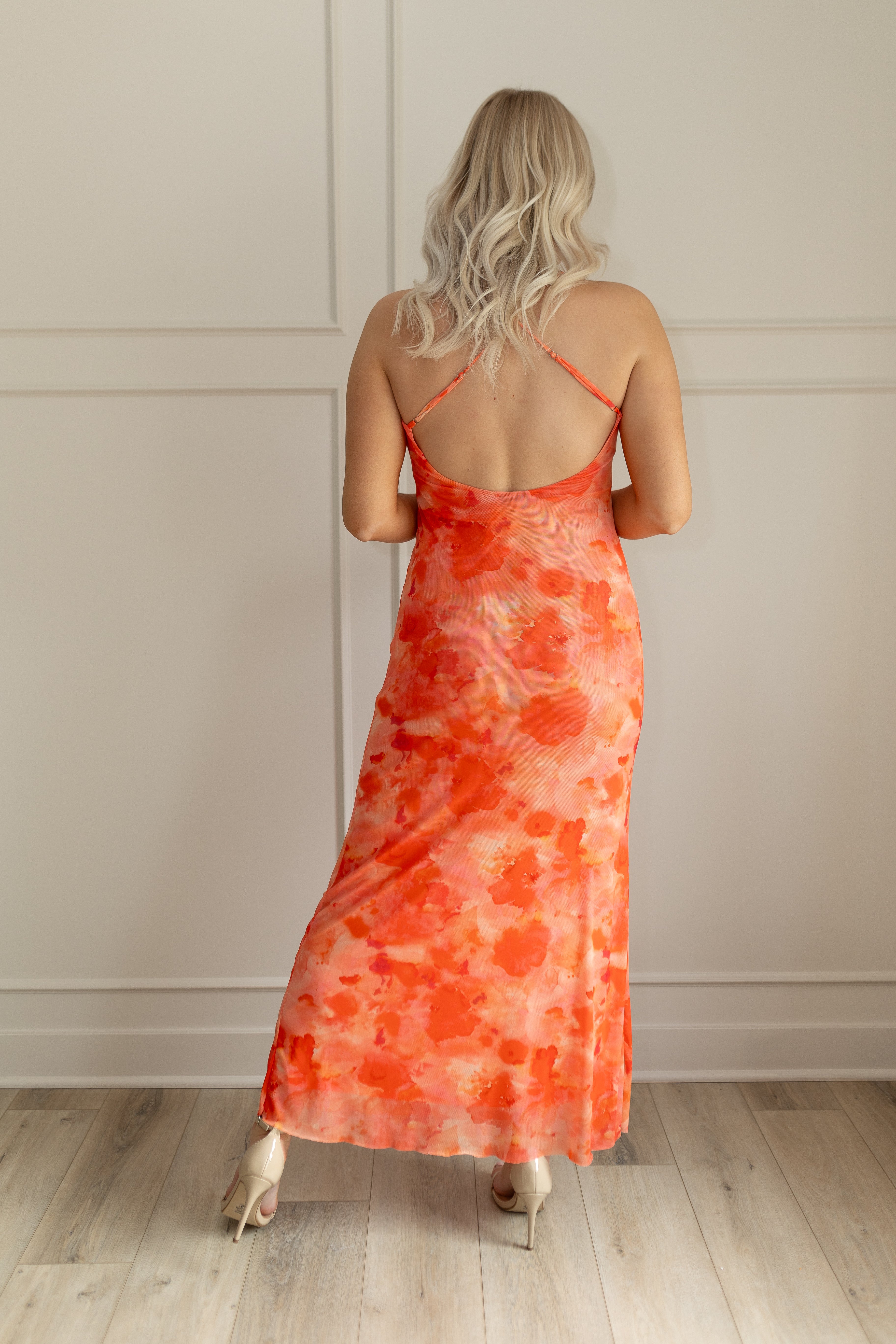 Orange mesh floral mini dress with adjustable spaghetti straps and keyhole cutout. 