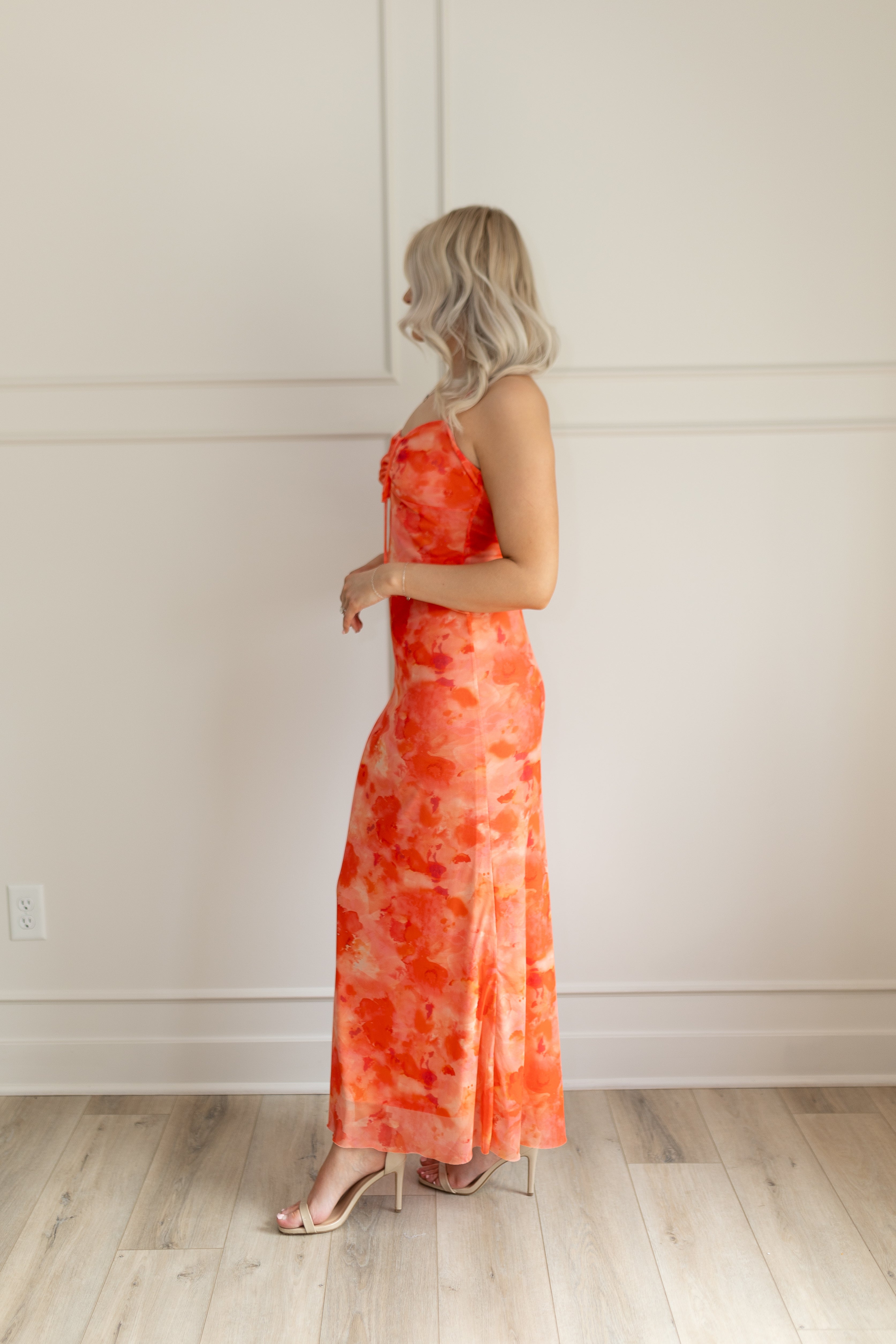 Orange mesh floral mini dress with adjustable spaghetti straps and keyhole cutout. 
