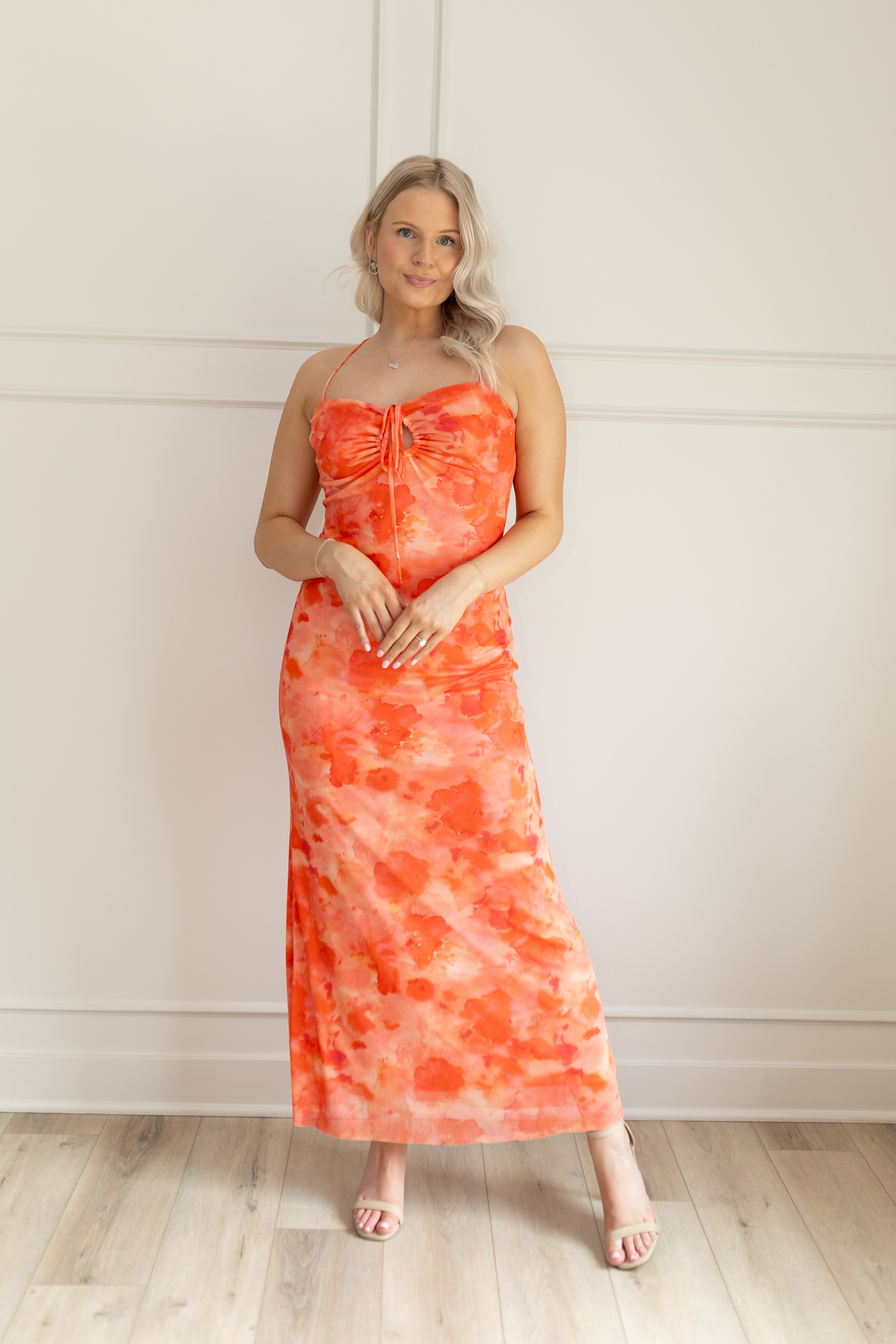 Orange mesh floral mini dress with adjustable spaghetti straps and keyhole cut out. 