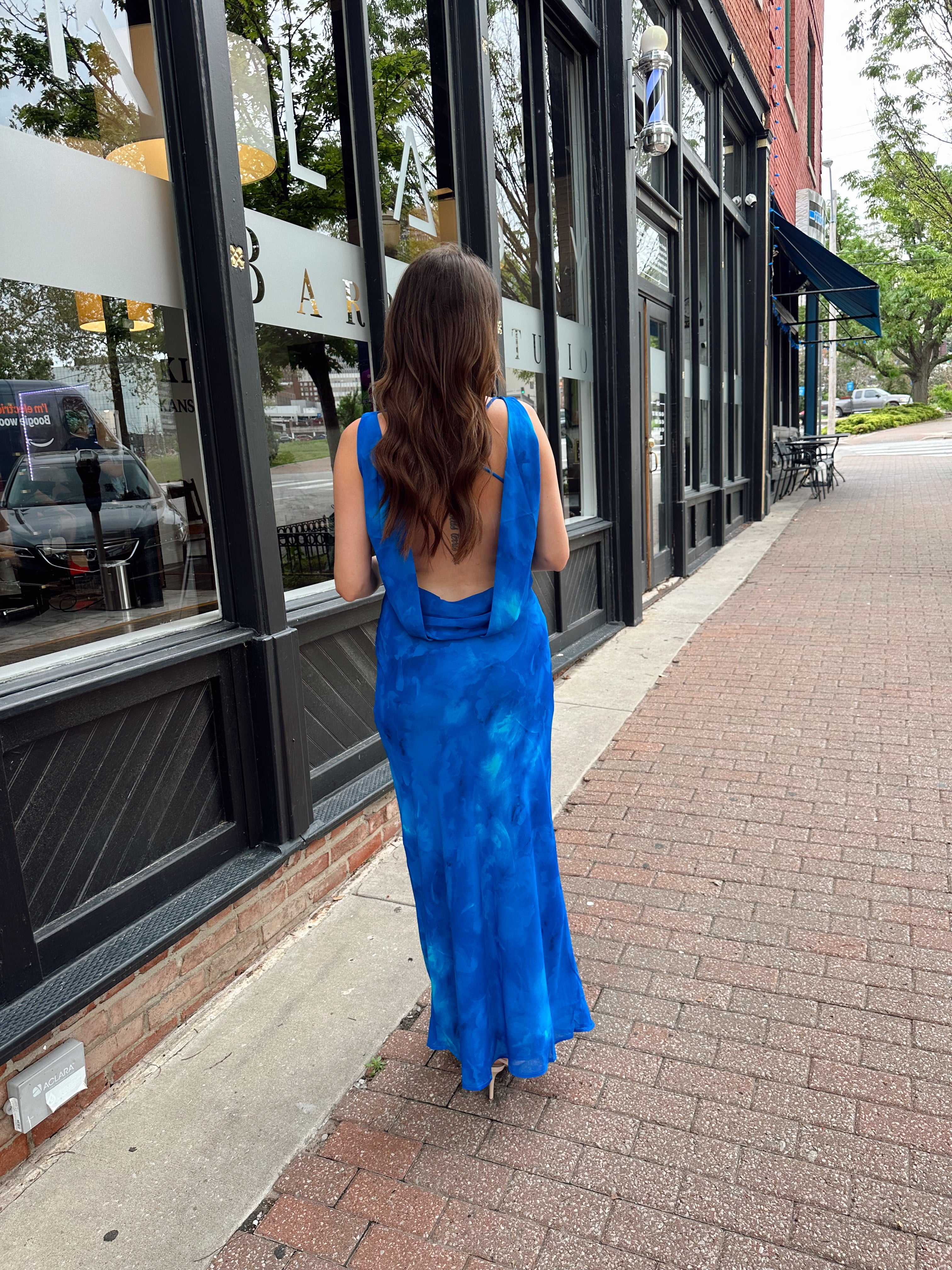 Blue watercolor maxi dress with v neckline and cowl back. 