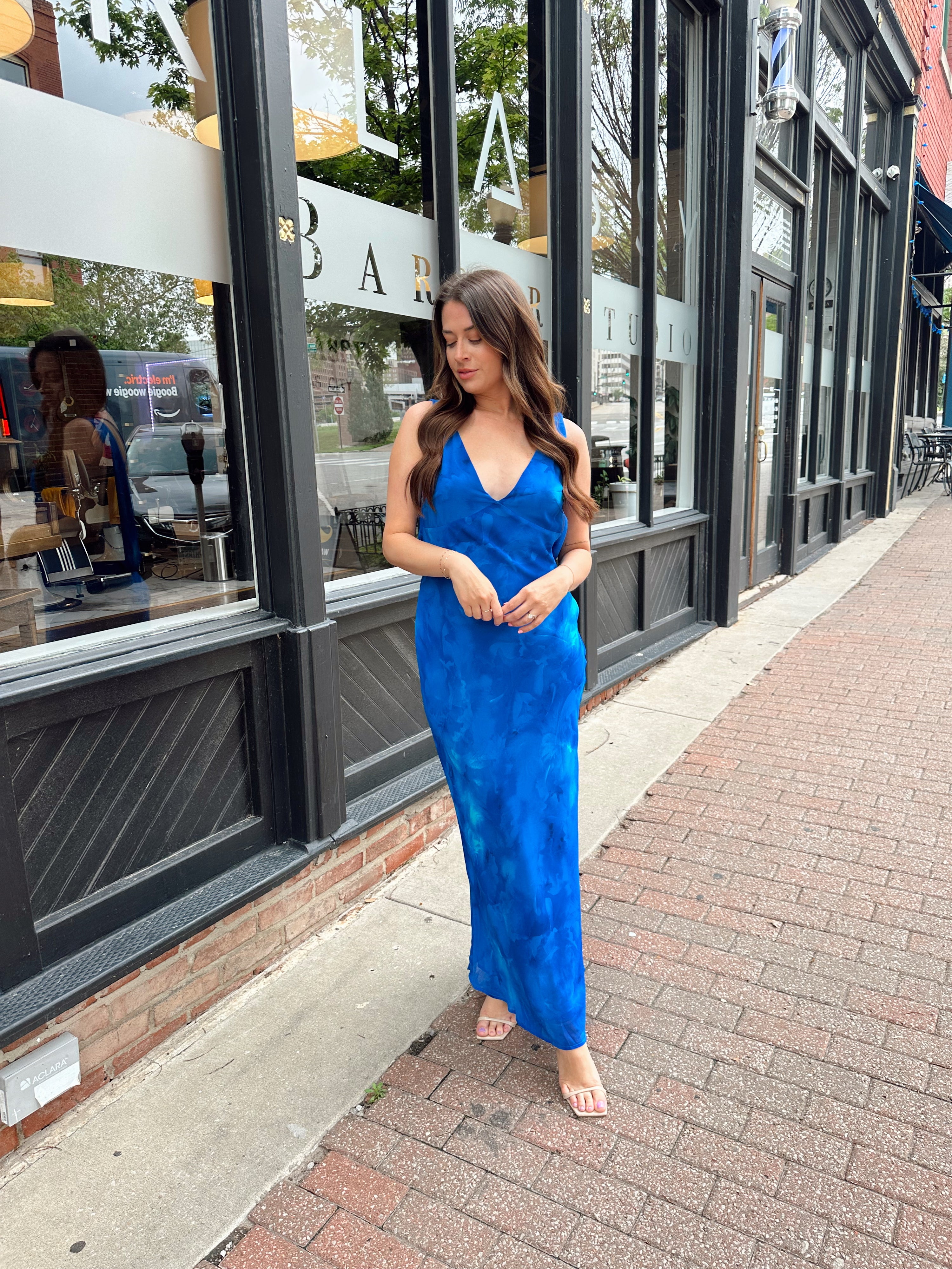 Blue watercolor maxi dress with v neckline and cowl back. 