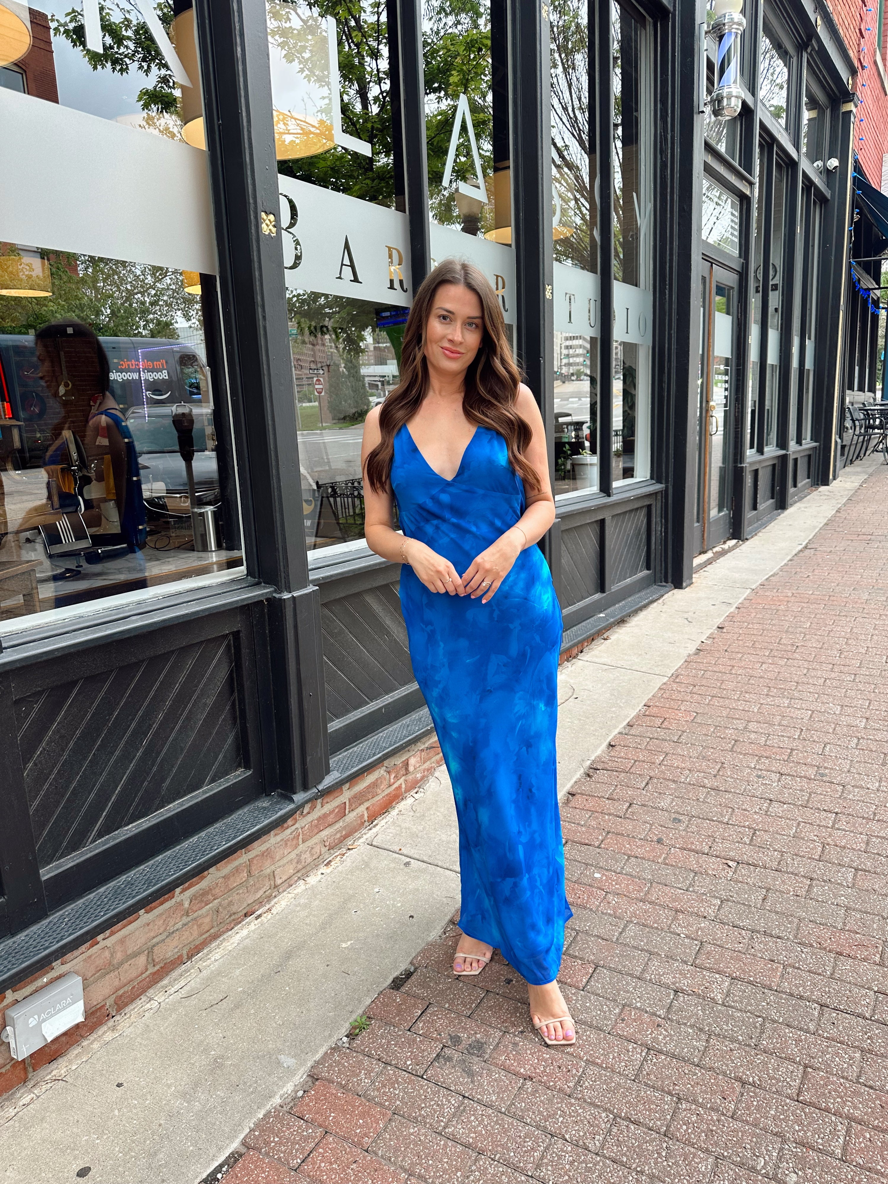 Blue watercolor maxi dress with v neckline and cowl back. 
