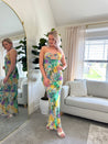 Purple and green tropical print maxi dress with cutout ring. 